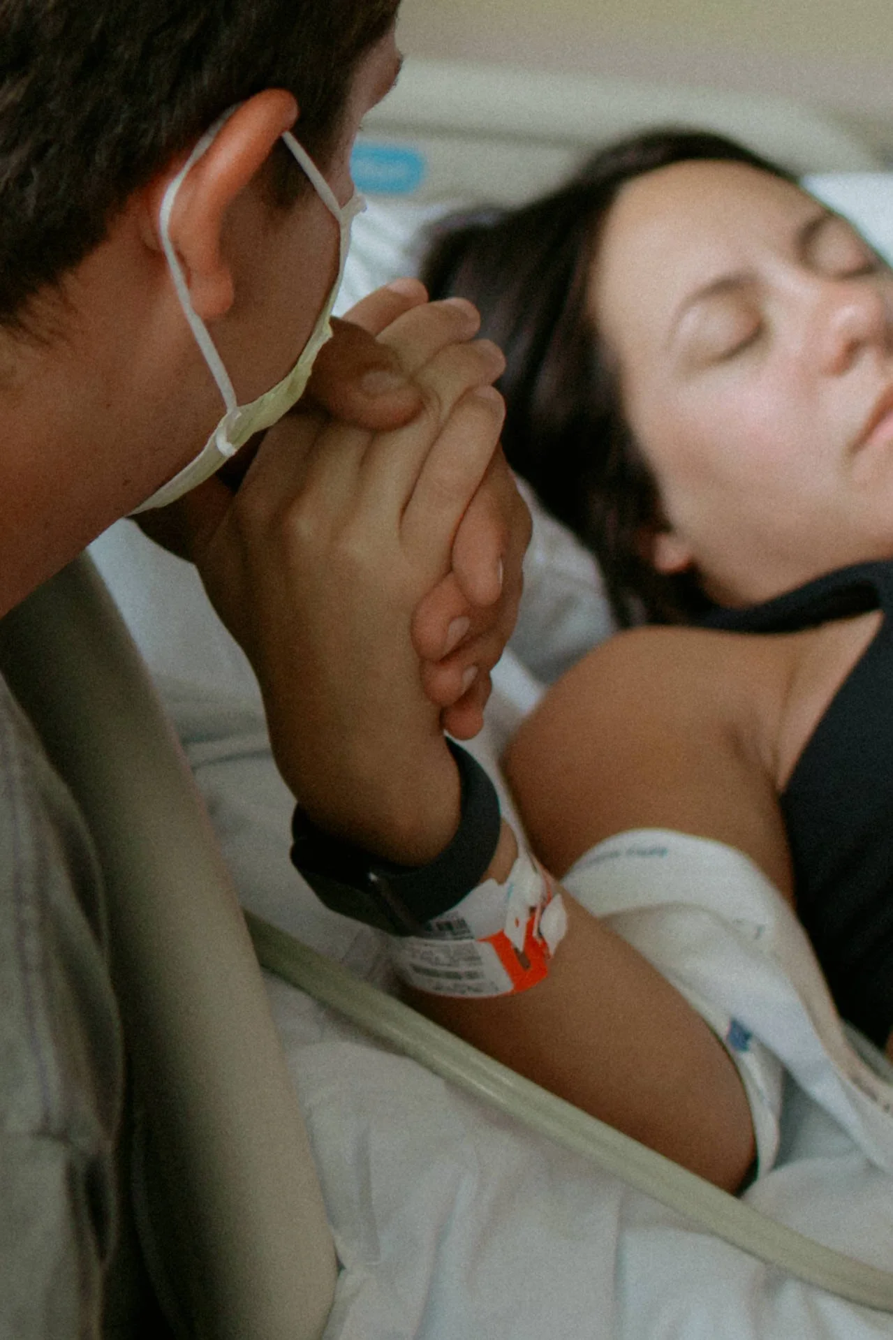 A new soon to be dad supporting his wife and new mom during labor in Mchenry County Illinois by Nicole Kilday