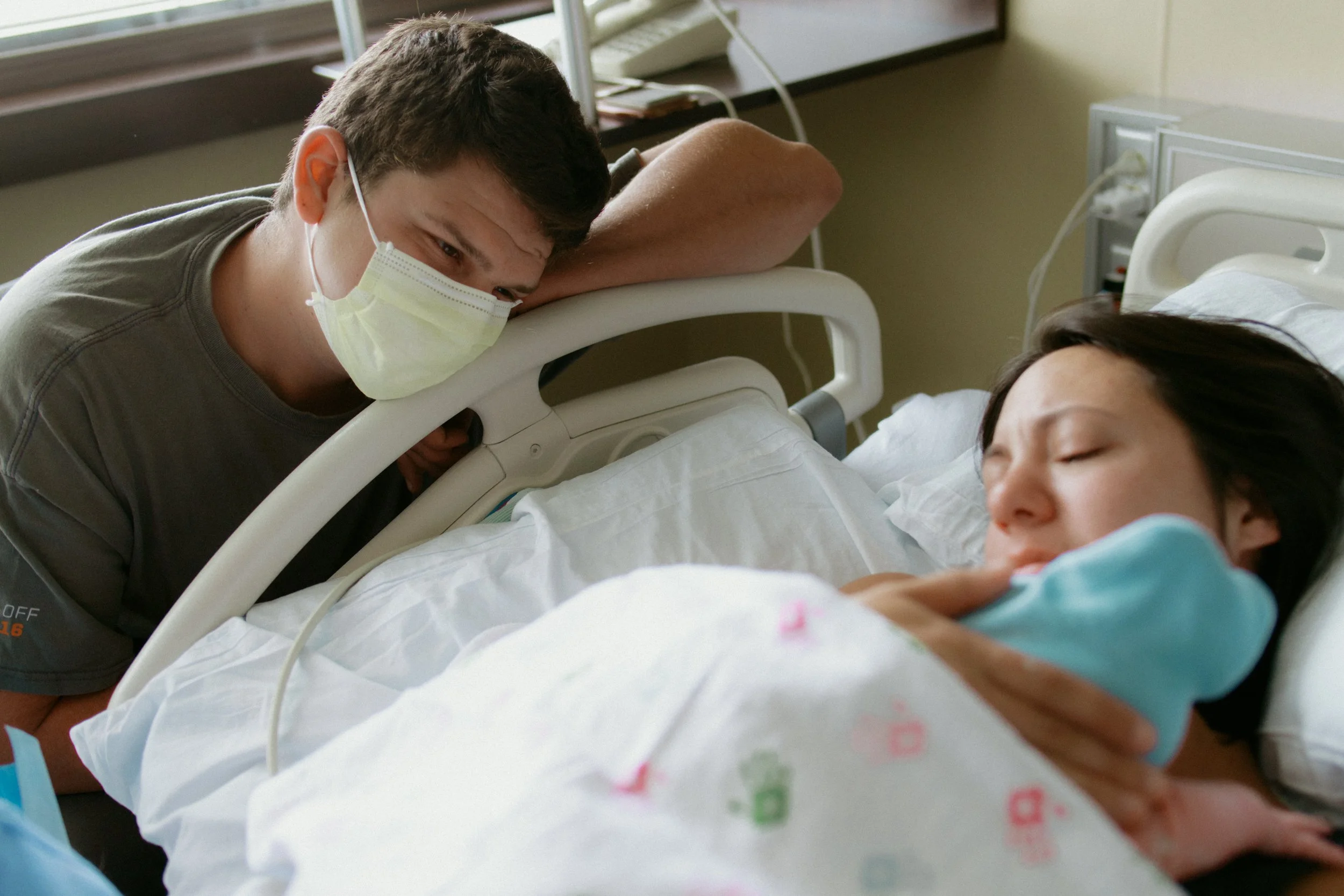 A new mom and dad embracing the golden hour right after delivery of their first born son in Mchenry County Illinois by Nicole Kilday