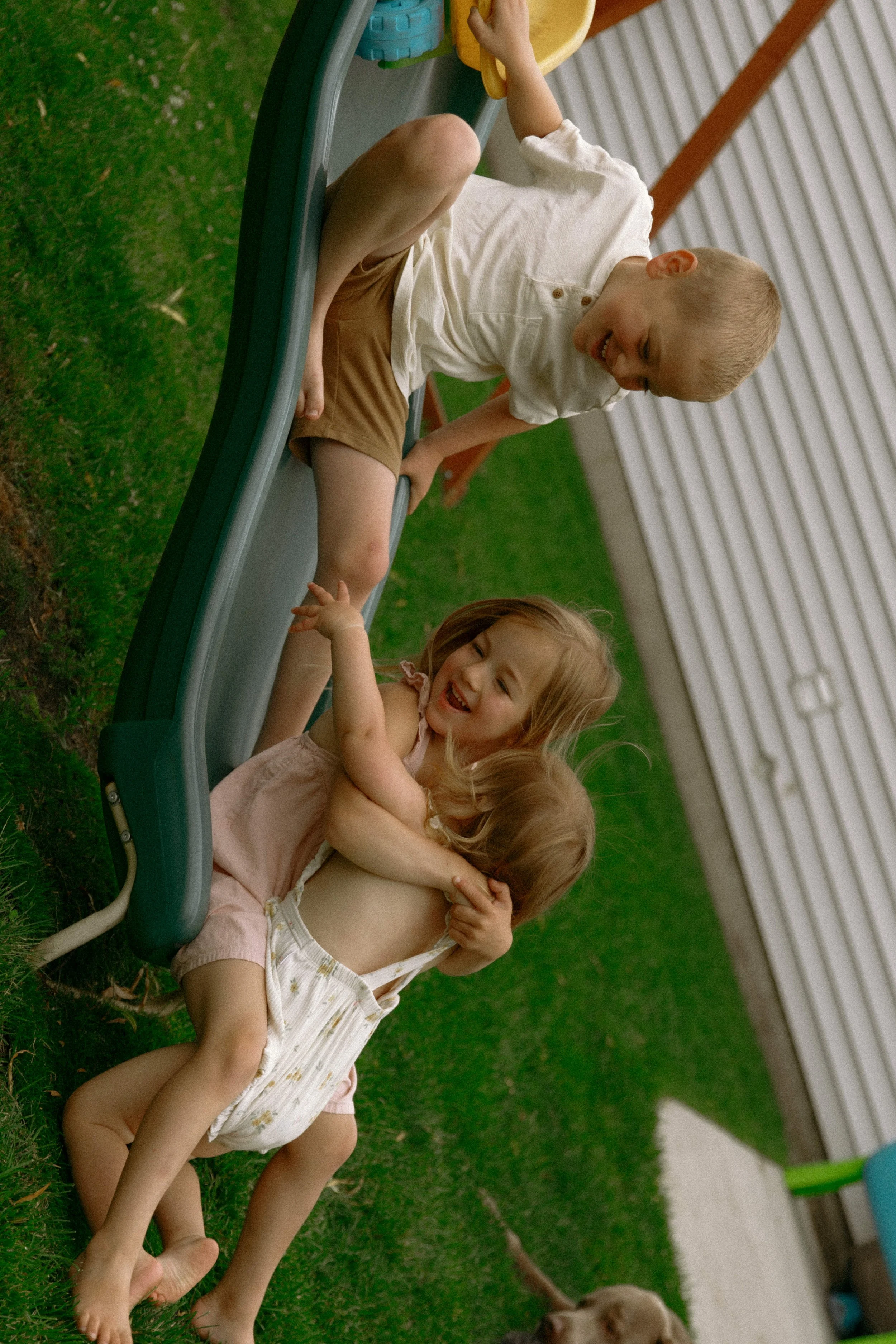 Children playing outdoors during a candid first year milestone photography session in McHenry County, Illinois.