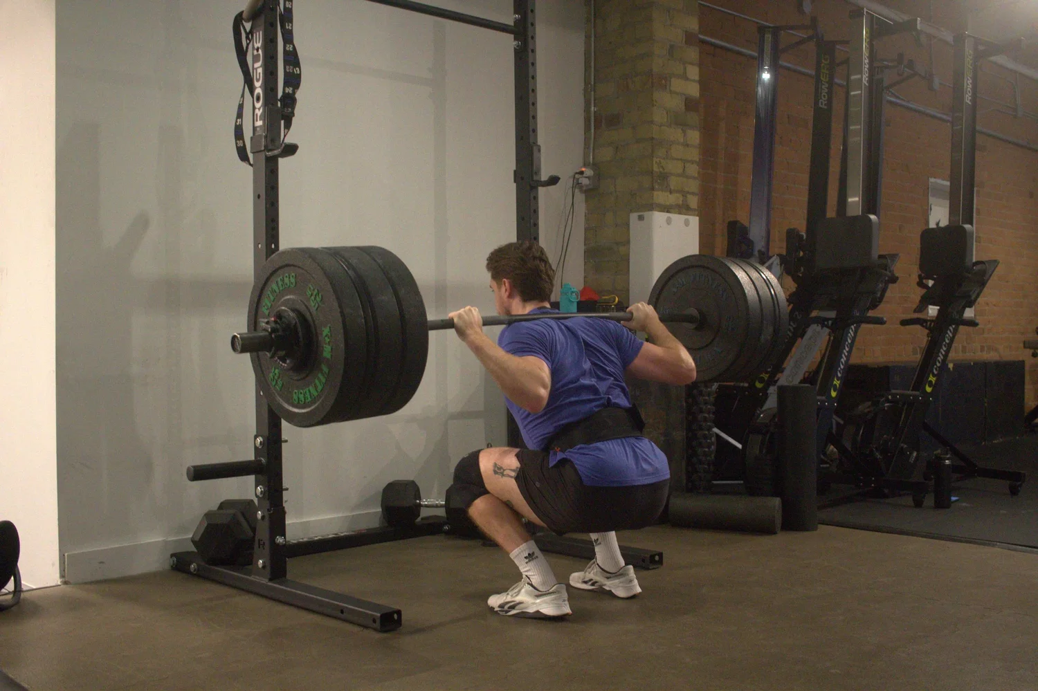 Athlete performing a barbell back squat at Empact Athletics in downtown Toronto