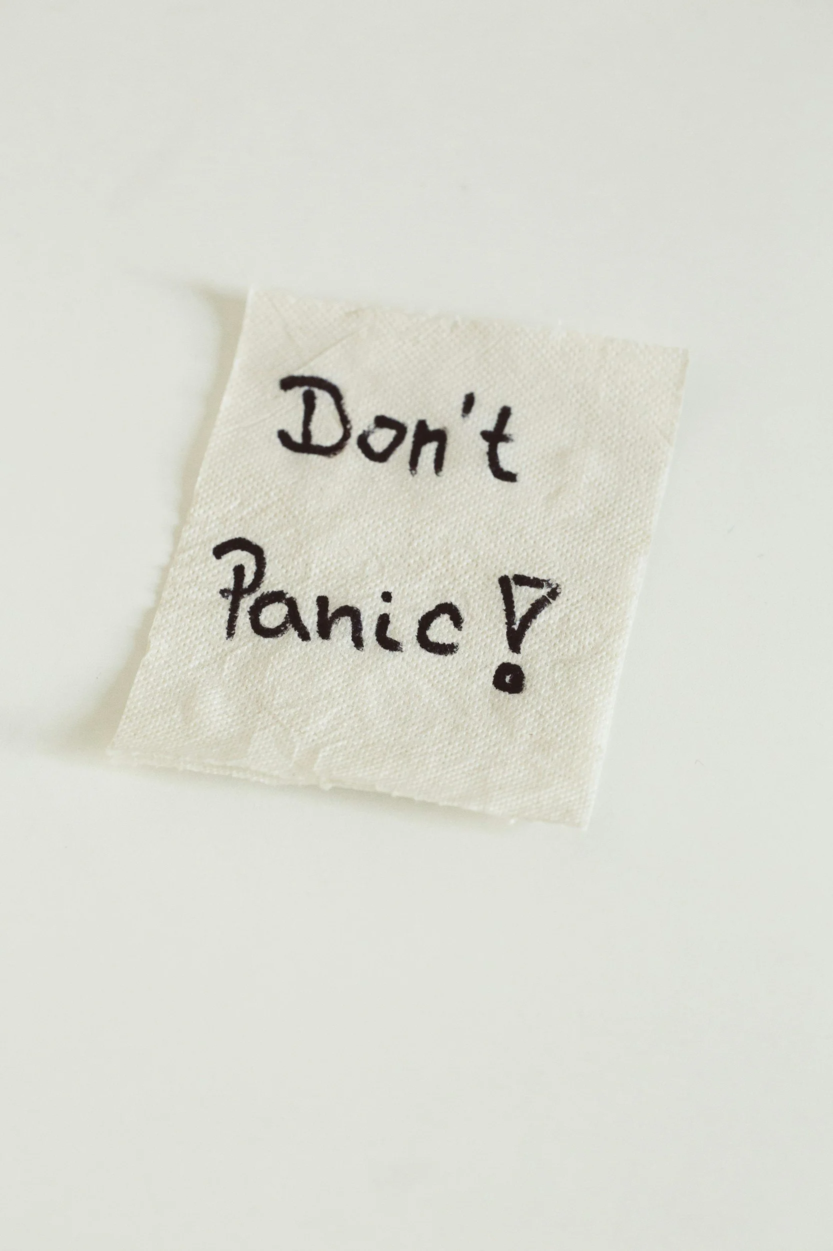 A tea bag with the handwritten message 'Don't Panic!'