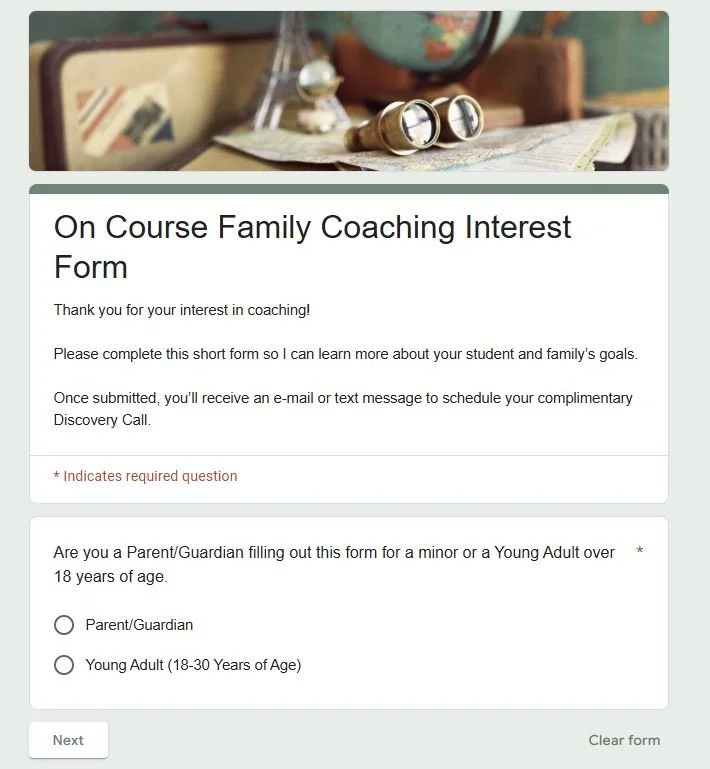 Family coaching interest form with a pair of binoculars and a globe on a desk.