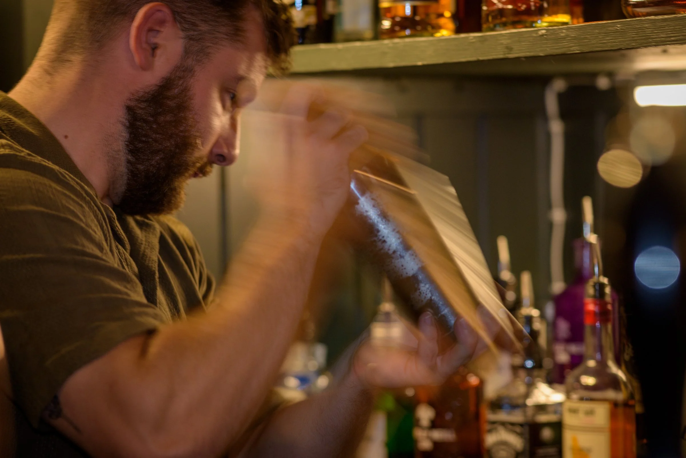 Bartender preparing cocktails at the bar as part of seasonal dishes and drinks