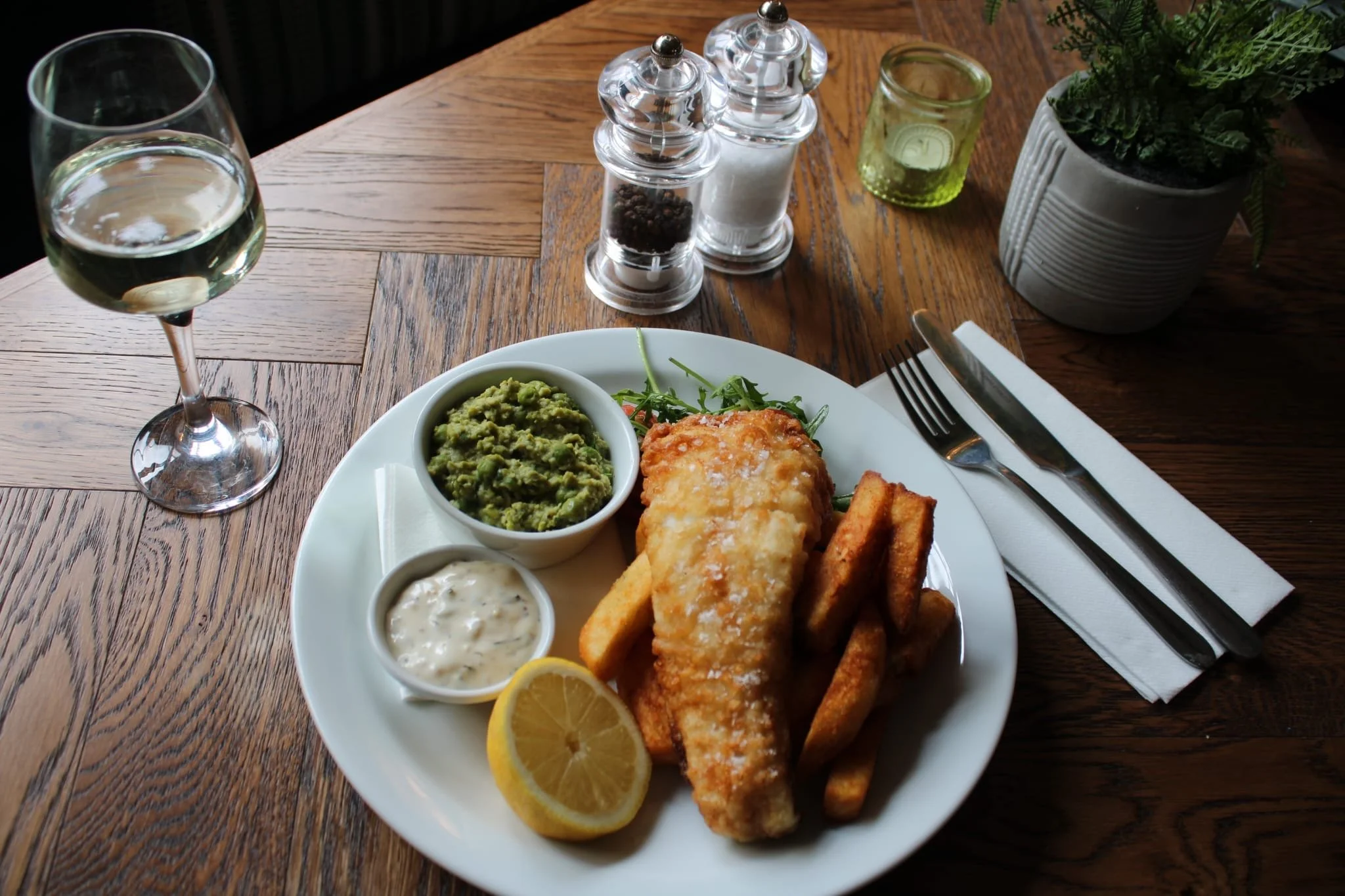 Seasonal dishes featuring traditional fish and chips with mushy peas and tartar sauce