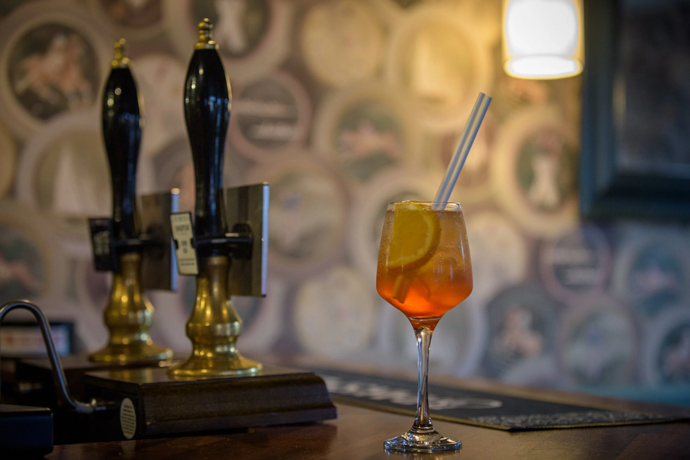 Refreshing Aperol spritz cocktail served at the bar alongside seasonal dishes