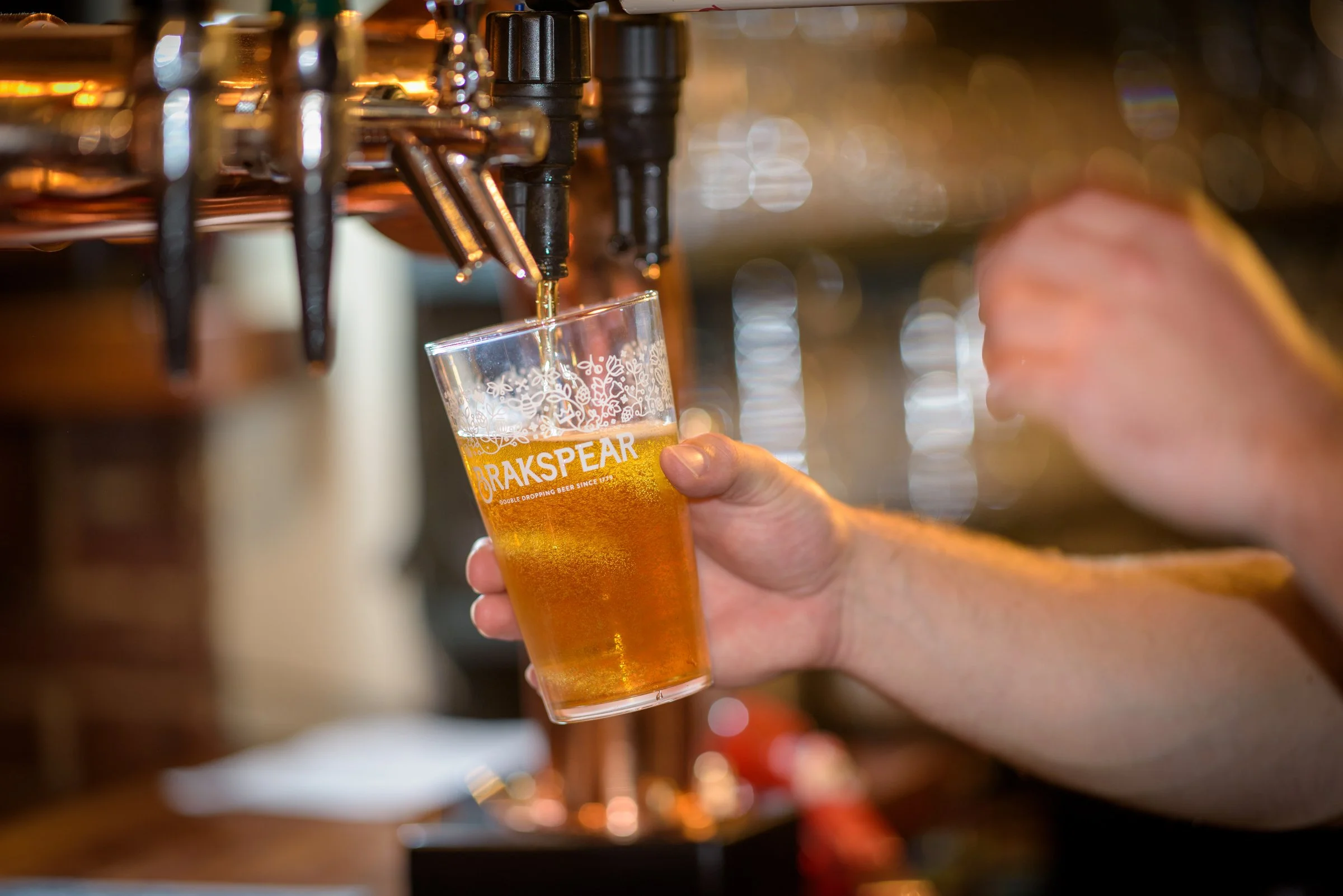 A pint of Brakspear ale being poured on tap, crafted to pair with hearty seasonal dishes
