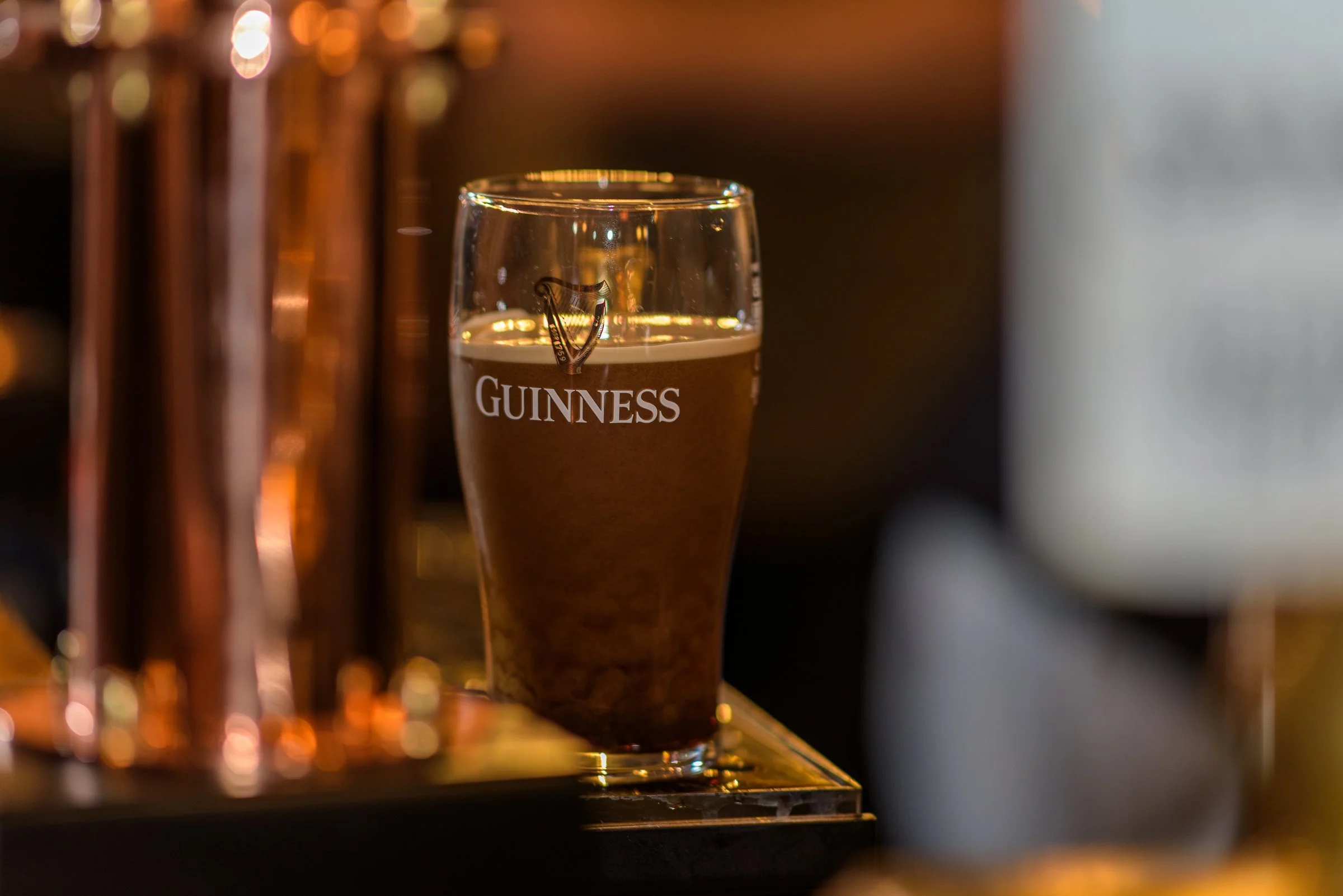 A freshly poured pint of Guinness on the bar, complementing seasonal dishes served at the pub