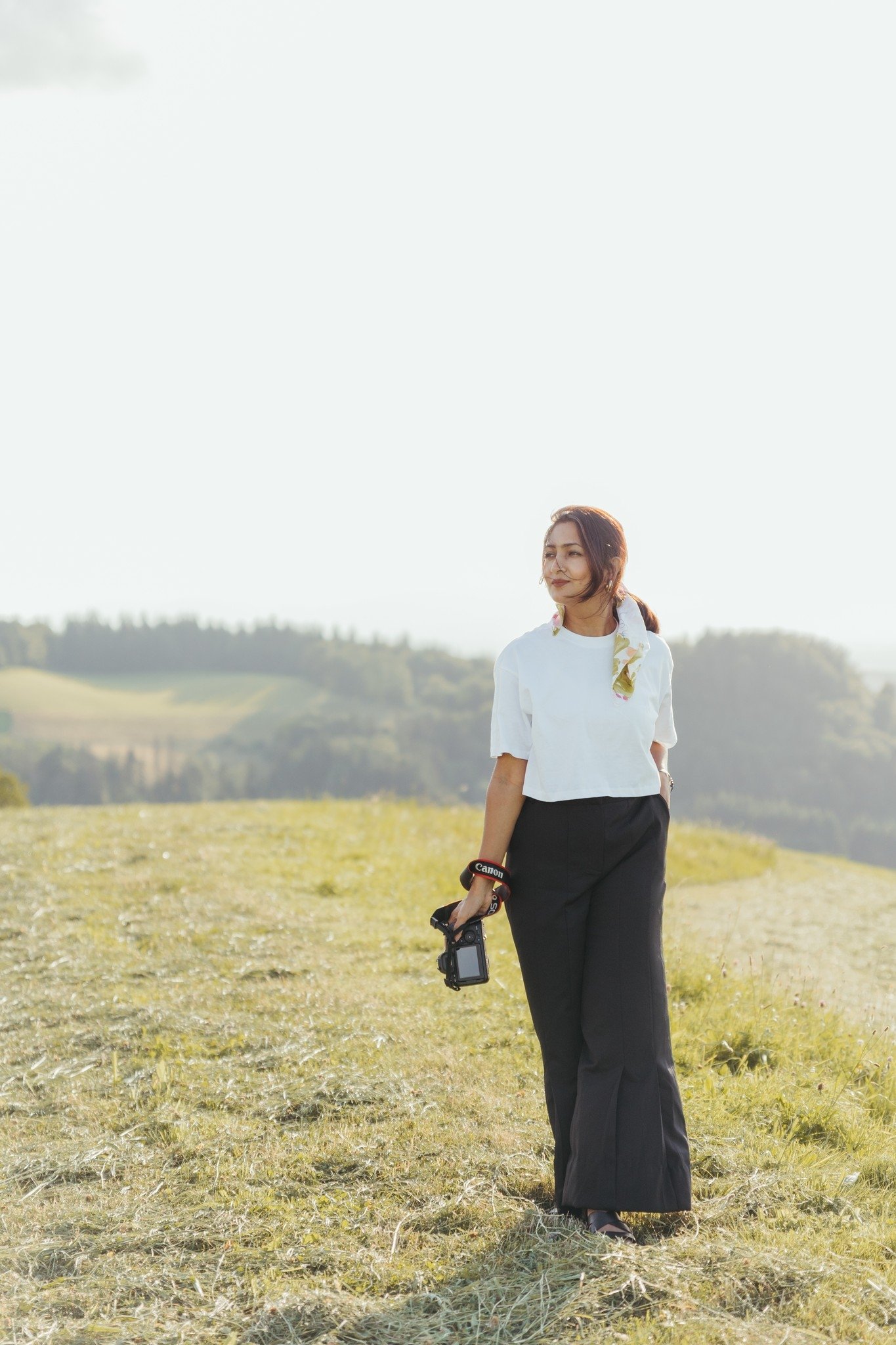 A wedding photographer in Connecticut holding her camera