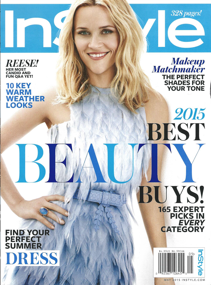 Cover of InStyle magazine featuring a woman with blonde, wavy hair, wearing a light blue dress with a textured, feather-like pattern, smiling at the camera.
