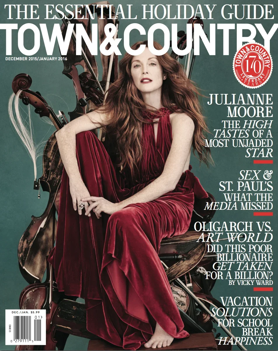 Cover of a magazine titled 'The Essential Holiday Guide Town & Country' featuring Julianna Moore sitting with a red velvet dress, with a background of magazines and musical instruments.