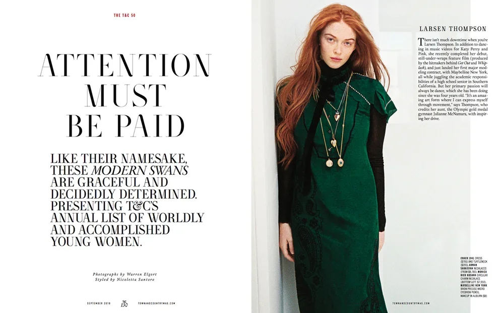 Magazine double-page spread with large text on the left page that reads 'Attention Must Be Paid' and smaller text below. The right page features a photo of a young woman with long red hair wearing a green dress with black sleeves and multiple layered
