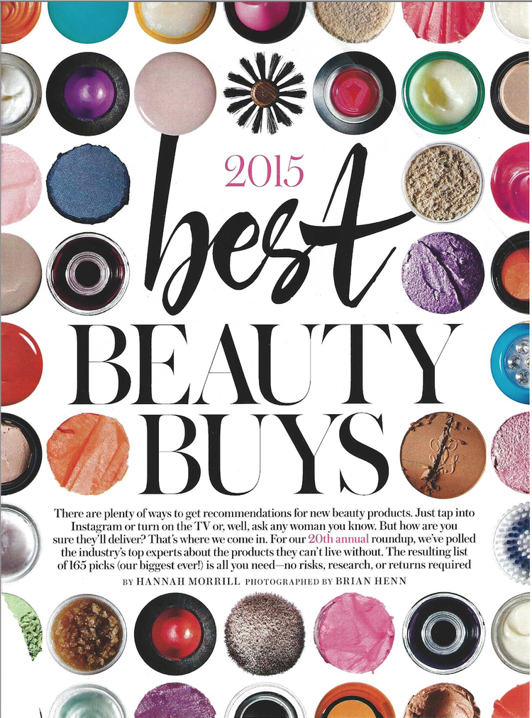 Cover of 2015 beauty magazine featuring an assortment of colorful makeup products and powders arranged around the text '2015 best beauty buys.'
