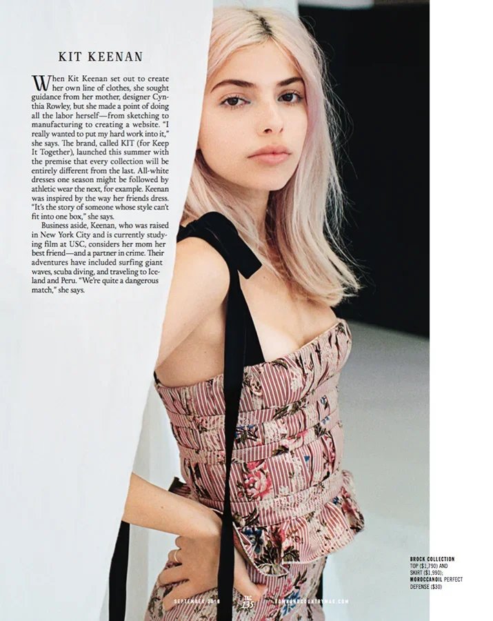 Page from magazine featuring a young woman with blonde hair wearing a sleeveless patterned dress with black strap, standing against a plain background.