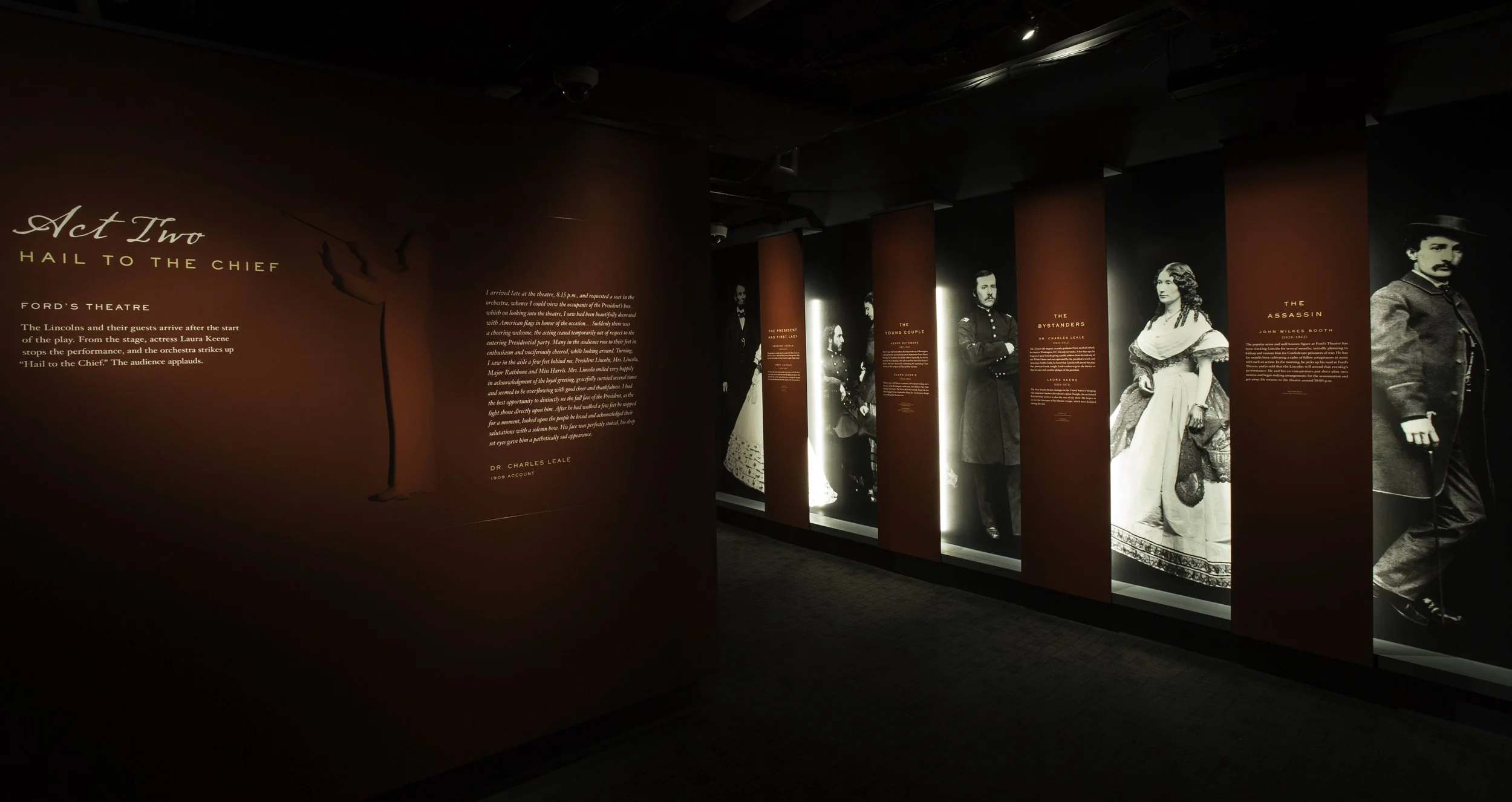 Exhibit titled 'Act Two Hail to the Chief' with black and white portraits of historical figures from the Civil War era on a red background, describing their roles in a theatrical performance.