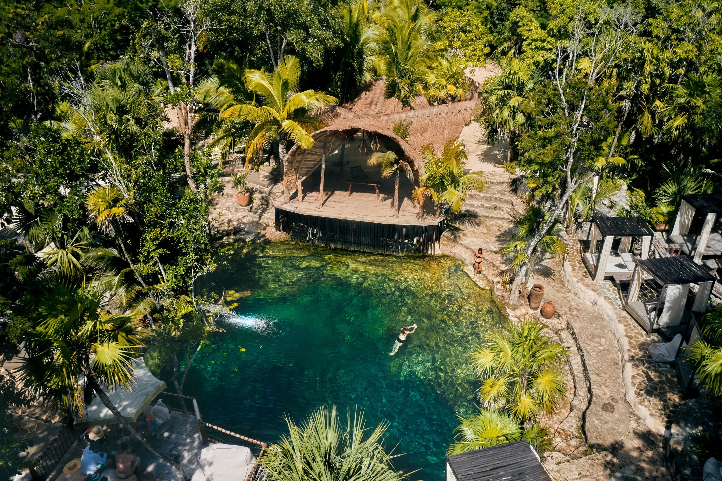 Tulum Cenote Day Club Vesica surrounded by a jungle 10 minutes drive from Villa Aniana Tukum. Lush tropical oasis with a beautiful cenote, live DJ, food and drinks all day long access
