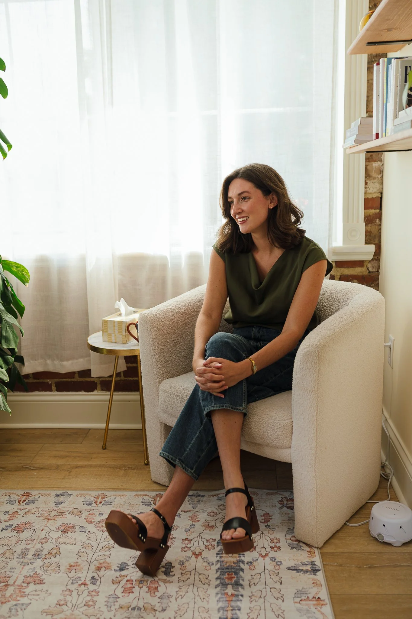 McLaine Beeman Mabry sitting in a cozy room, smiling, dressed in casual therapy outfit, providing marriage counseling in Nashville Tennessee.
