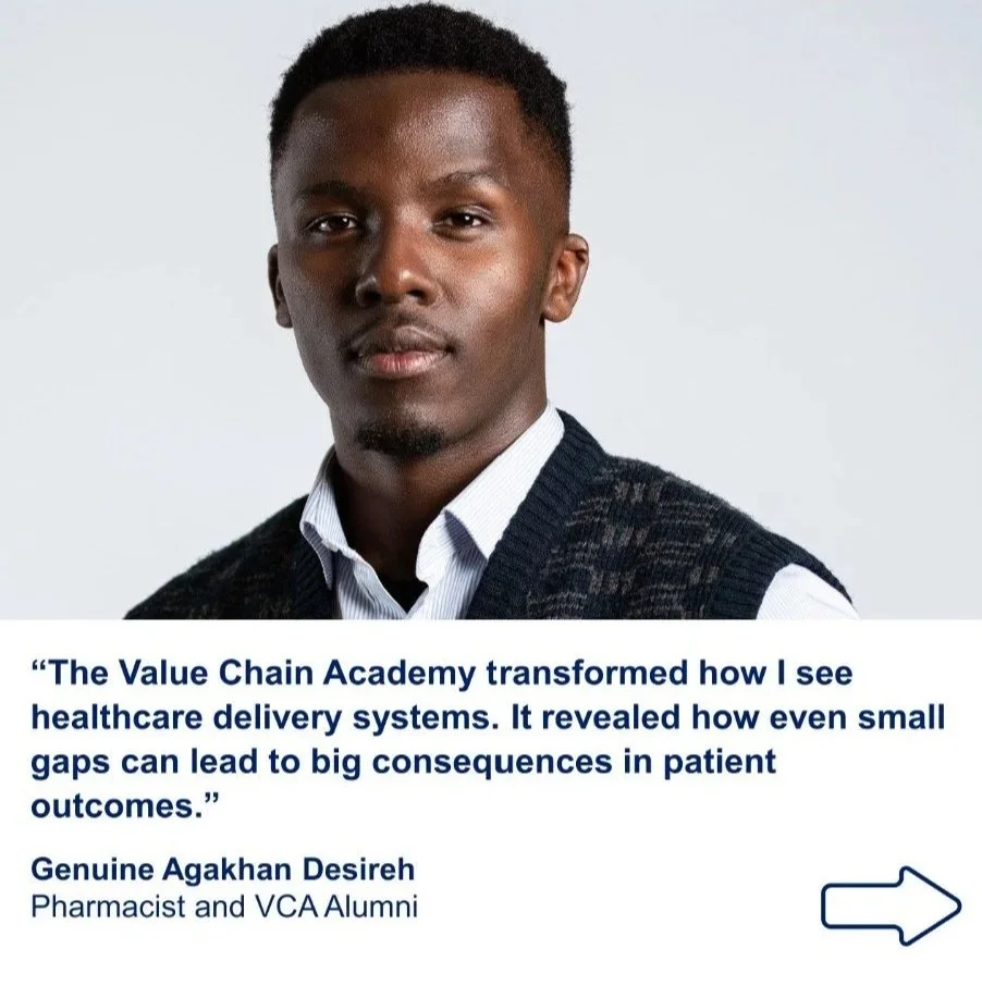 A young man with dark skin and short curly hair wearing a collared shirt and a dark sweater, looking at the camera against a plain light background.