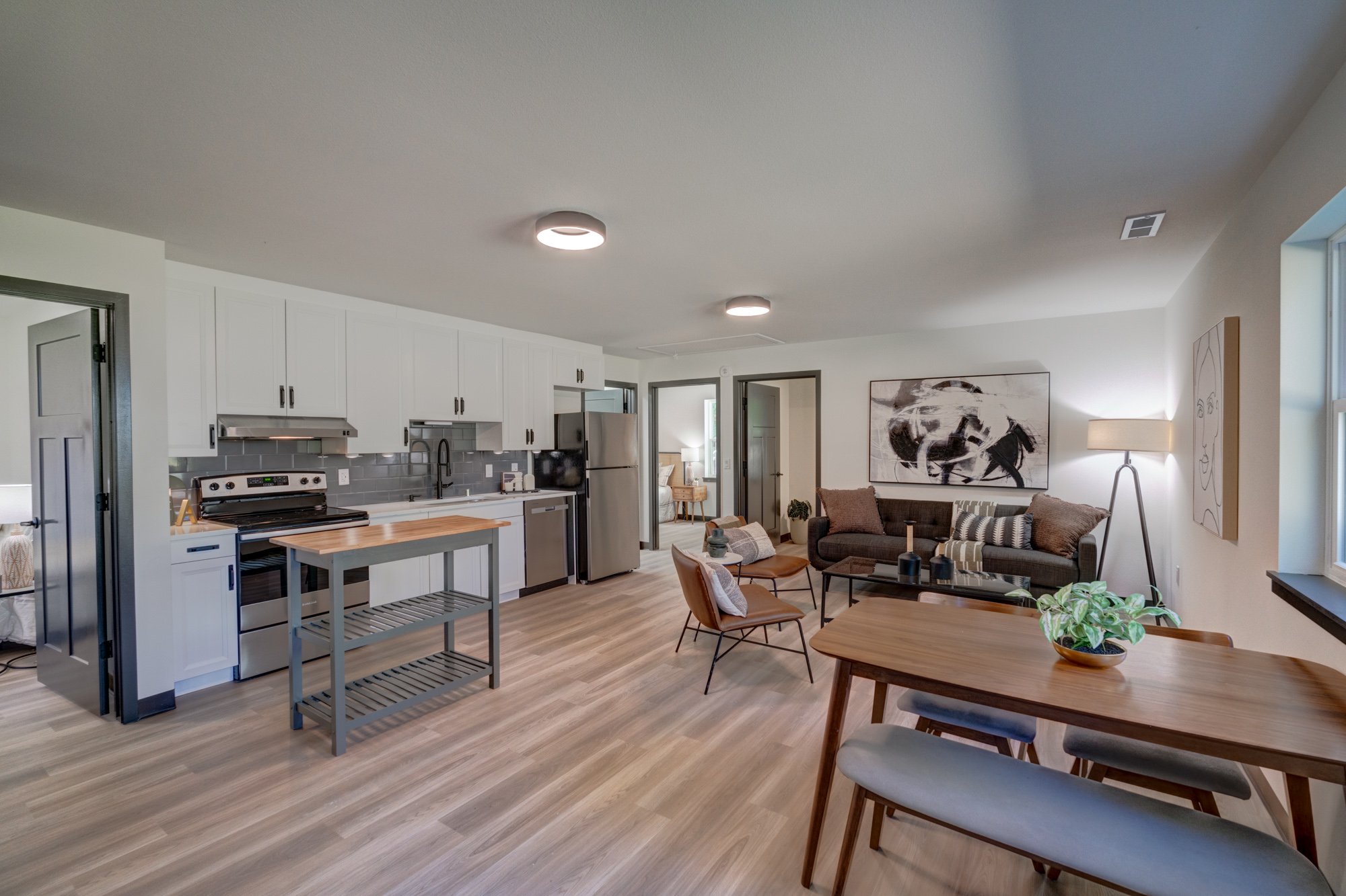 Open floor plan with continuous LVP flooring to support safe, smooth wheelchair mobility