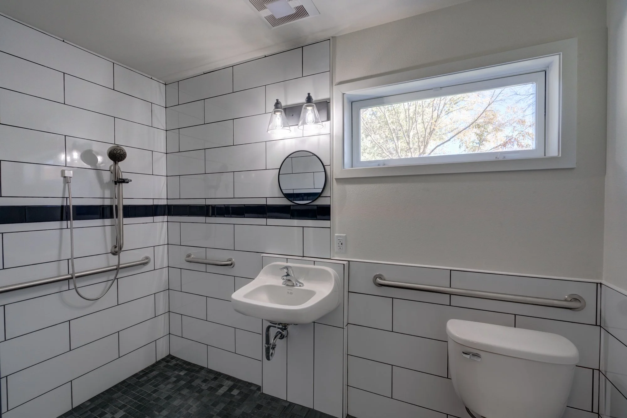 Fully tiled, roll-in shower room designed for wheelchair accessibility 