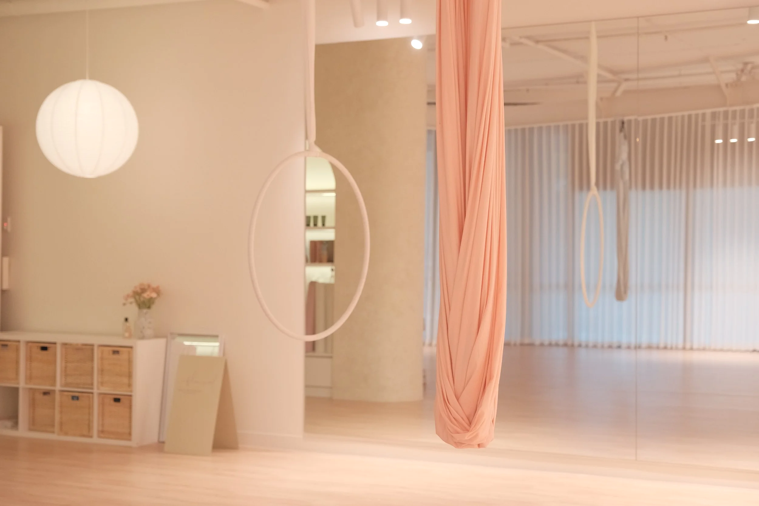 Minimal, cozy aerial studio in Melbourne CBD with soft lighting, aerial hammock, and calm Korean-inspired interior.