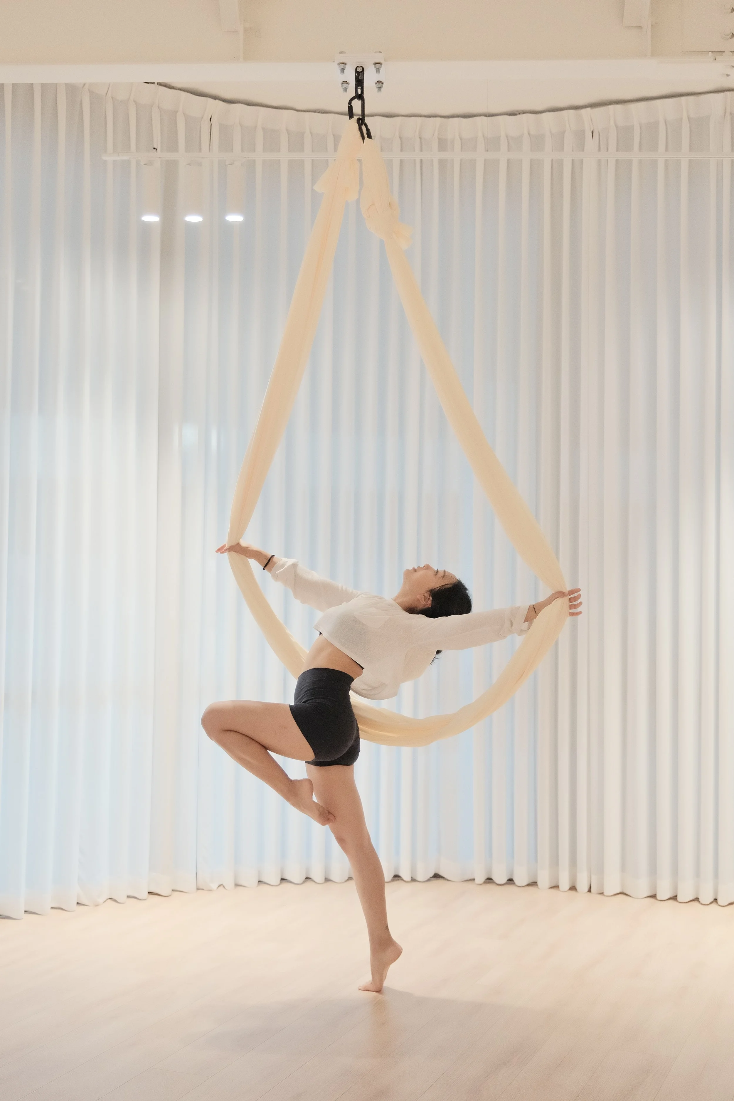 Minimal aerial silks setup in a clean studio in Melbourne CBD with soft tones and spacious layout for flow.