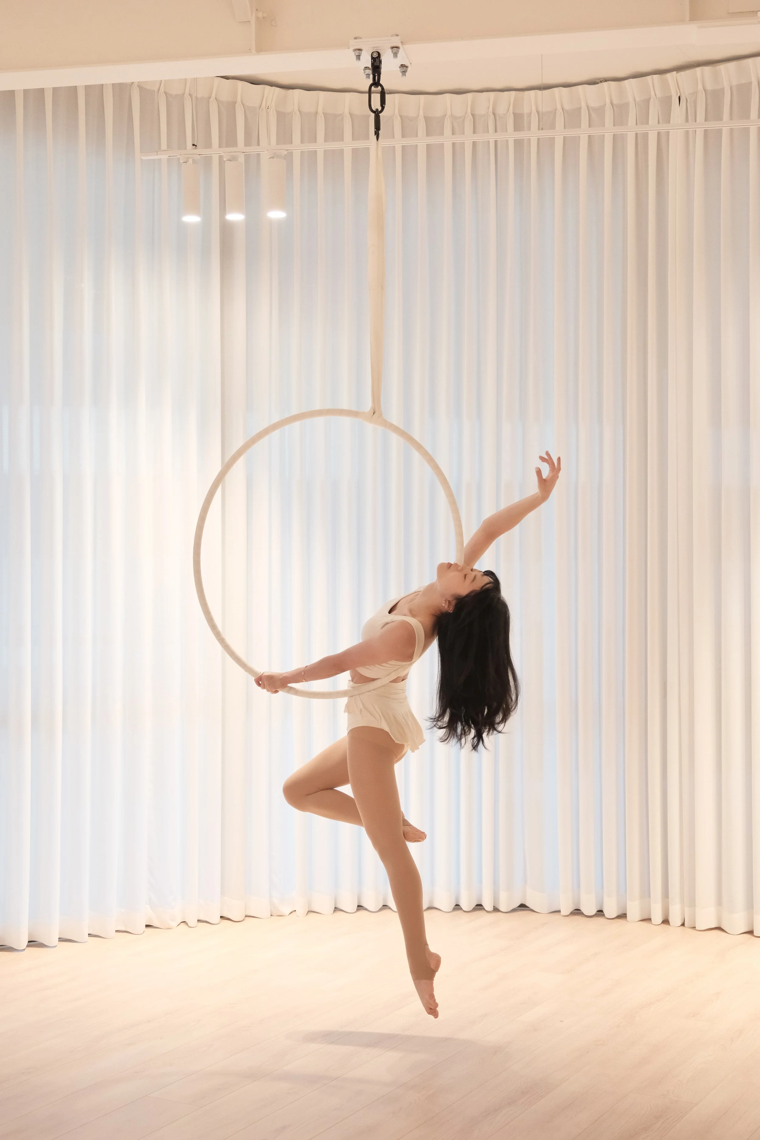 Aerial hoop studio in Melbourne CBD Australia with minimal, cozy interior and clean open space for training and flow.