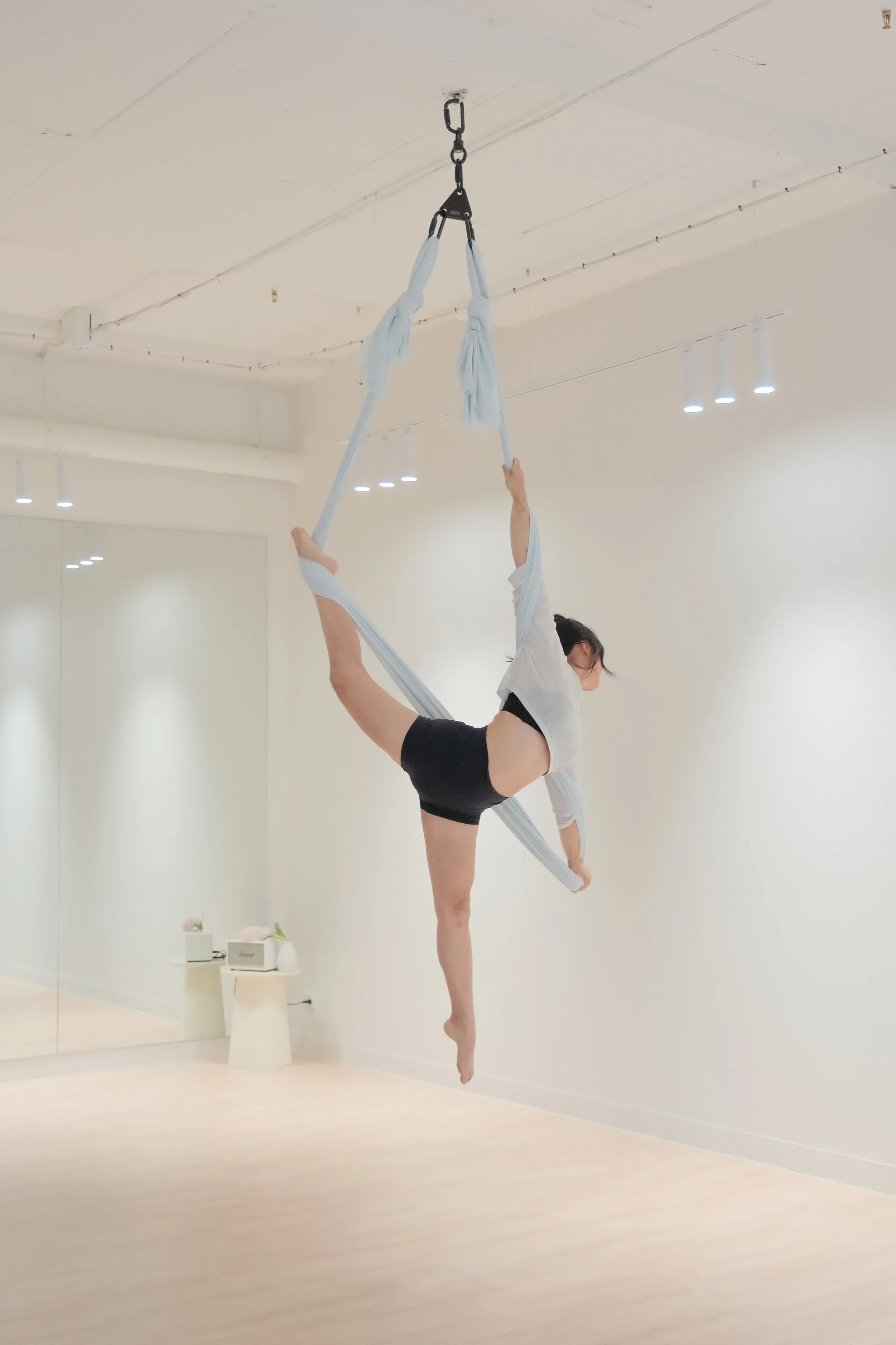 Cozy aerial hammock space in Melbourne CBD with soft fabric drops, natural light, and a calm studio atmosphere.