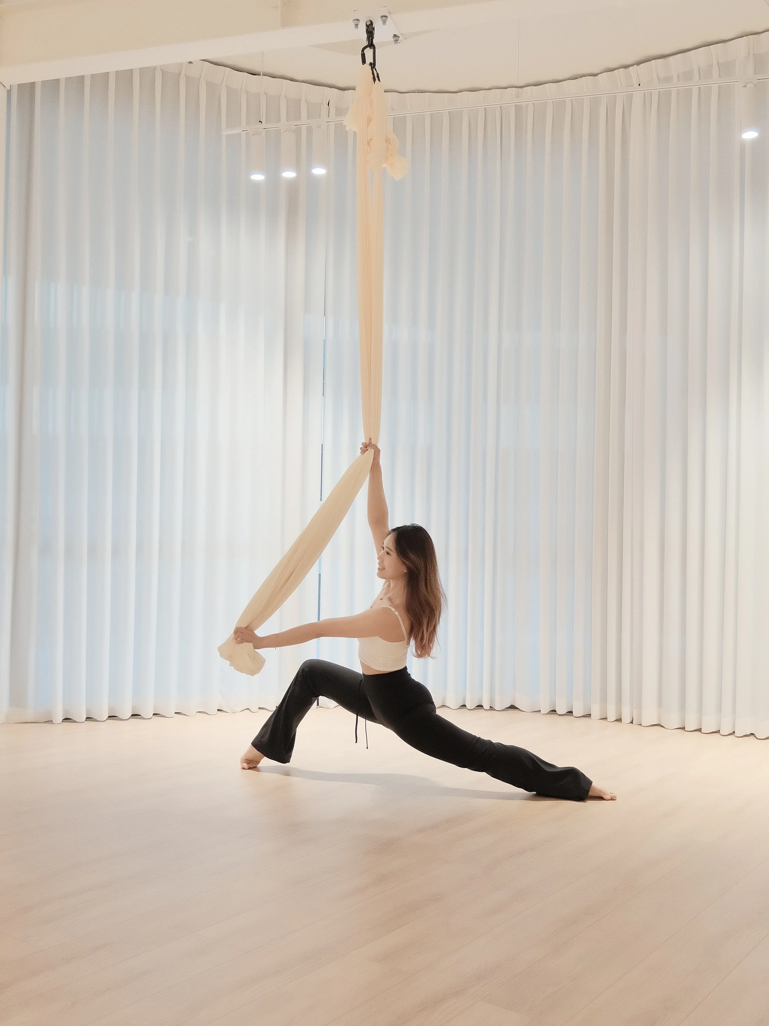 Flowy aerial hammock studio in Melbourne CBD with light-filled space and soft, minimal design.
