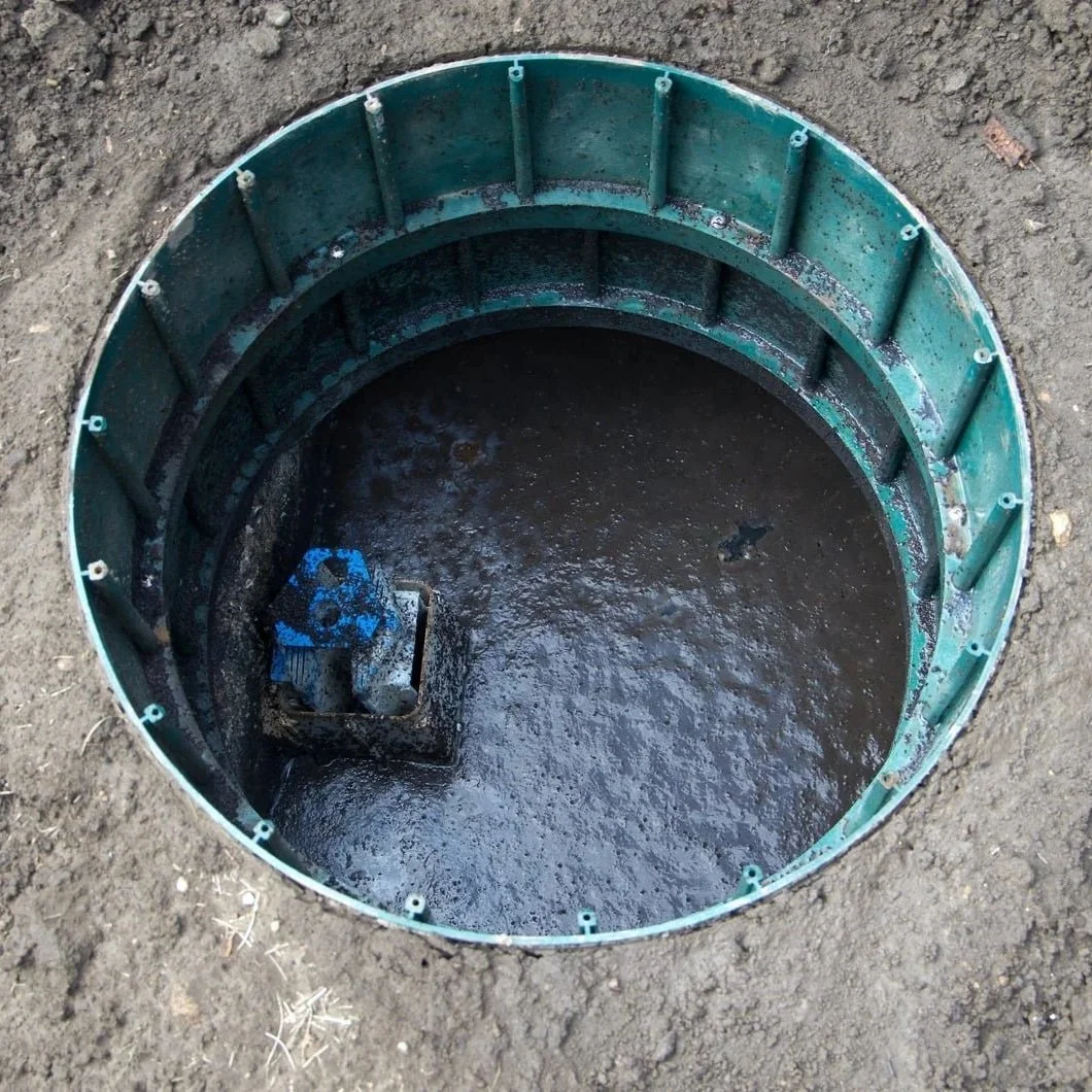 septic tank overflowing with wastewater near house