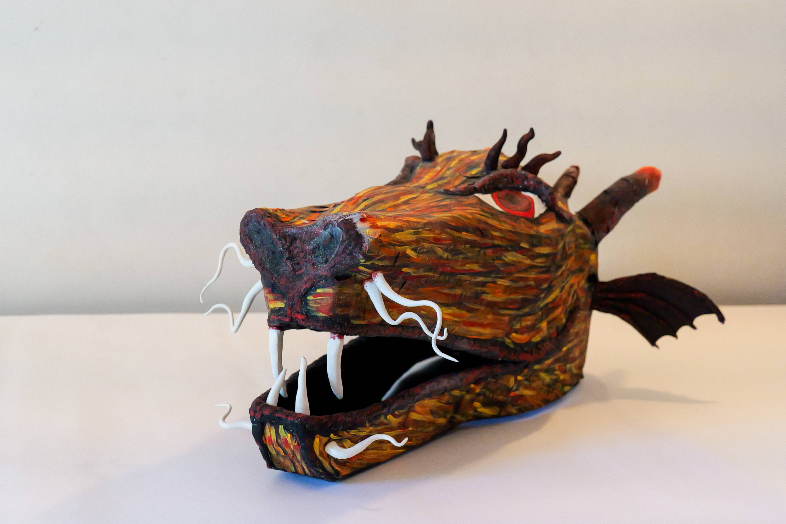 Fully functional Dragon Head mask made out of Papier Mache and painted with acrylic paint. 