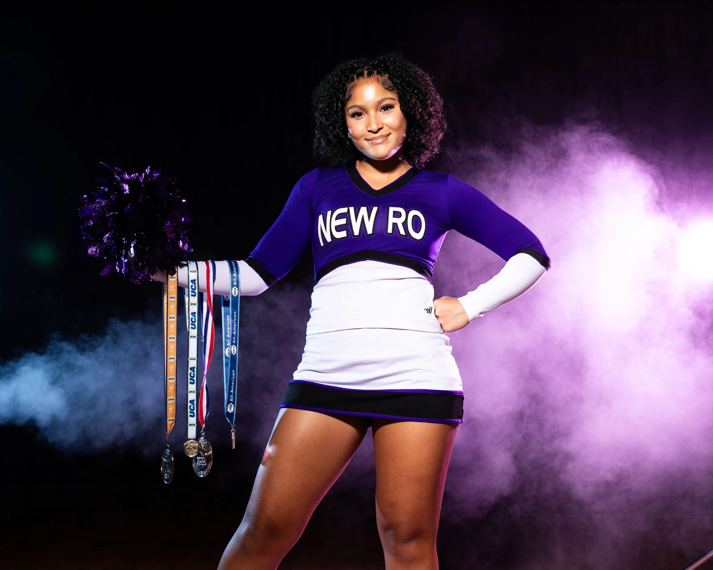 portrait_modes_new_rochelle_cheer_media_day_holding_medals.jpeg