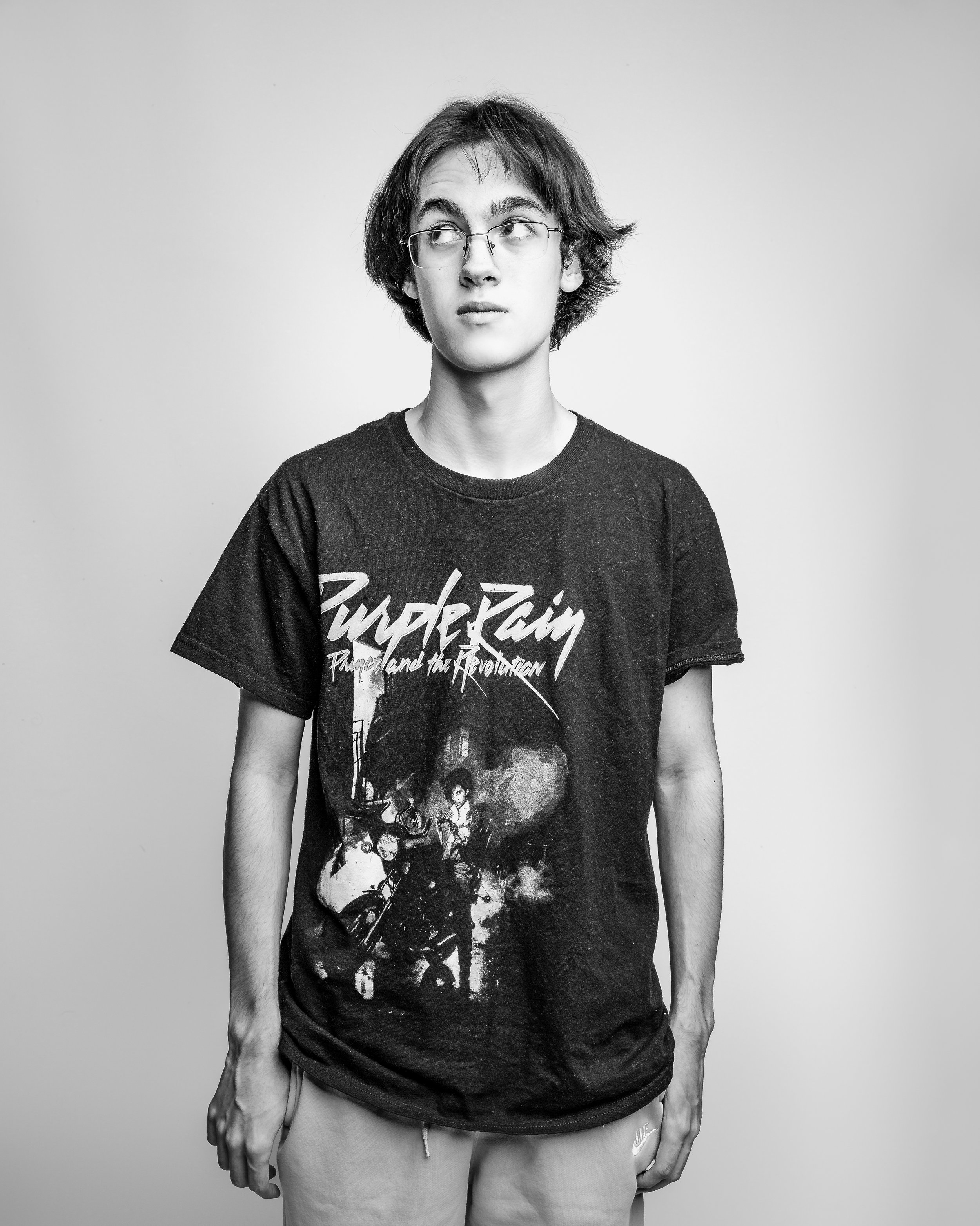 Black-and-white studio portrait of a young man looking off to the side