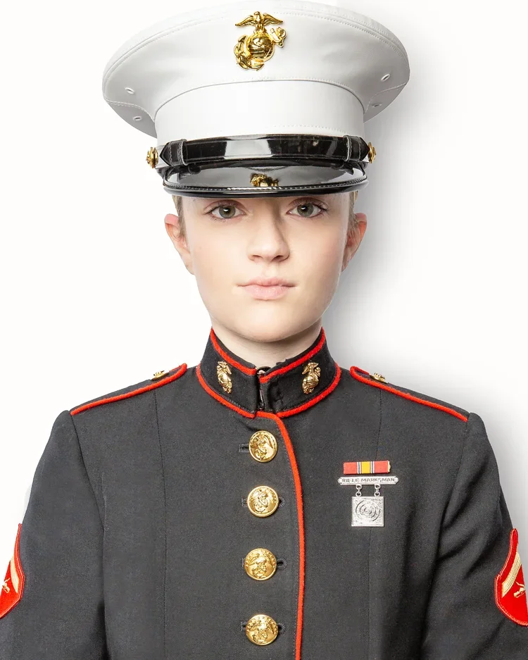 Professional headshot of a U.S. Marine in dress uniform photographed on a white background.