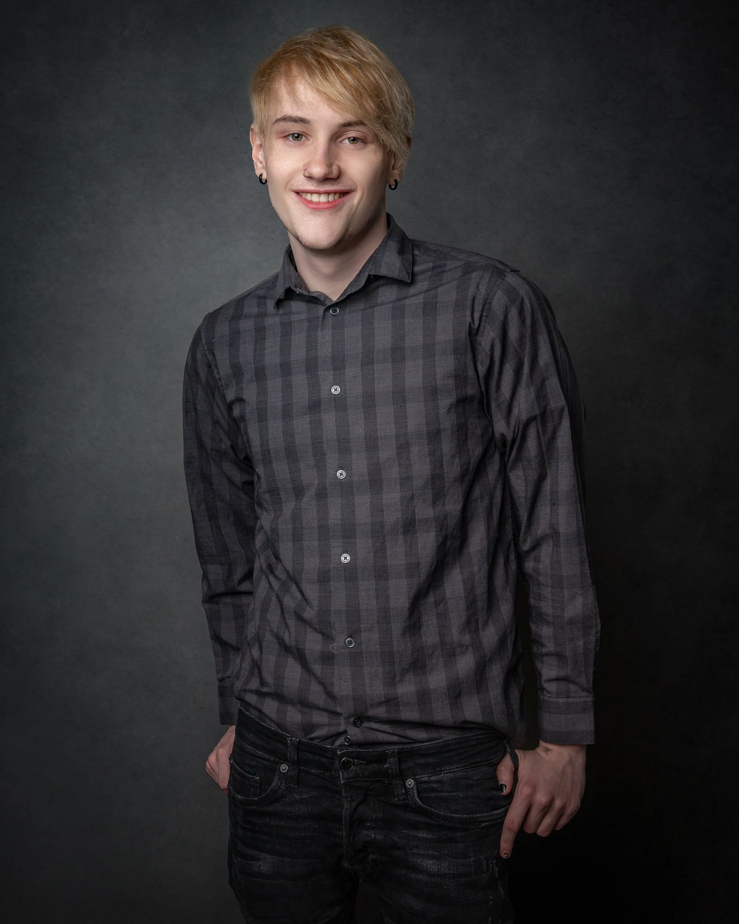 Young EMO smiling during a studio senior portrait session.