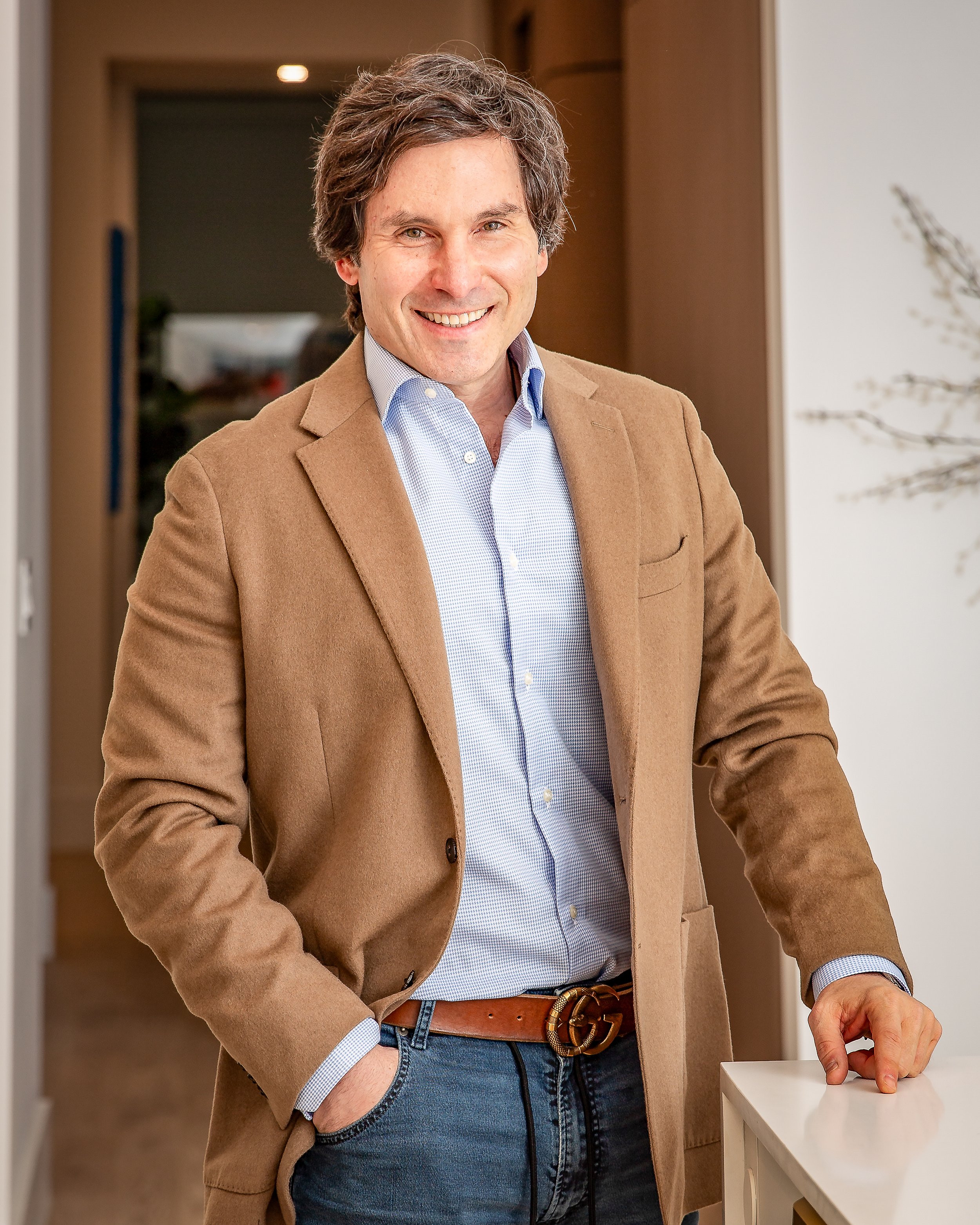 Environmental business headshot of a professional photographed in a modern office with natural light.