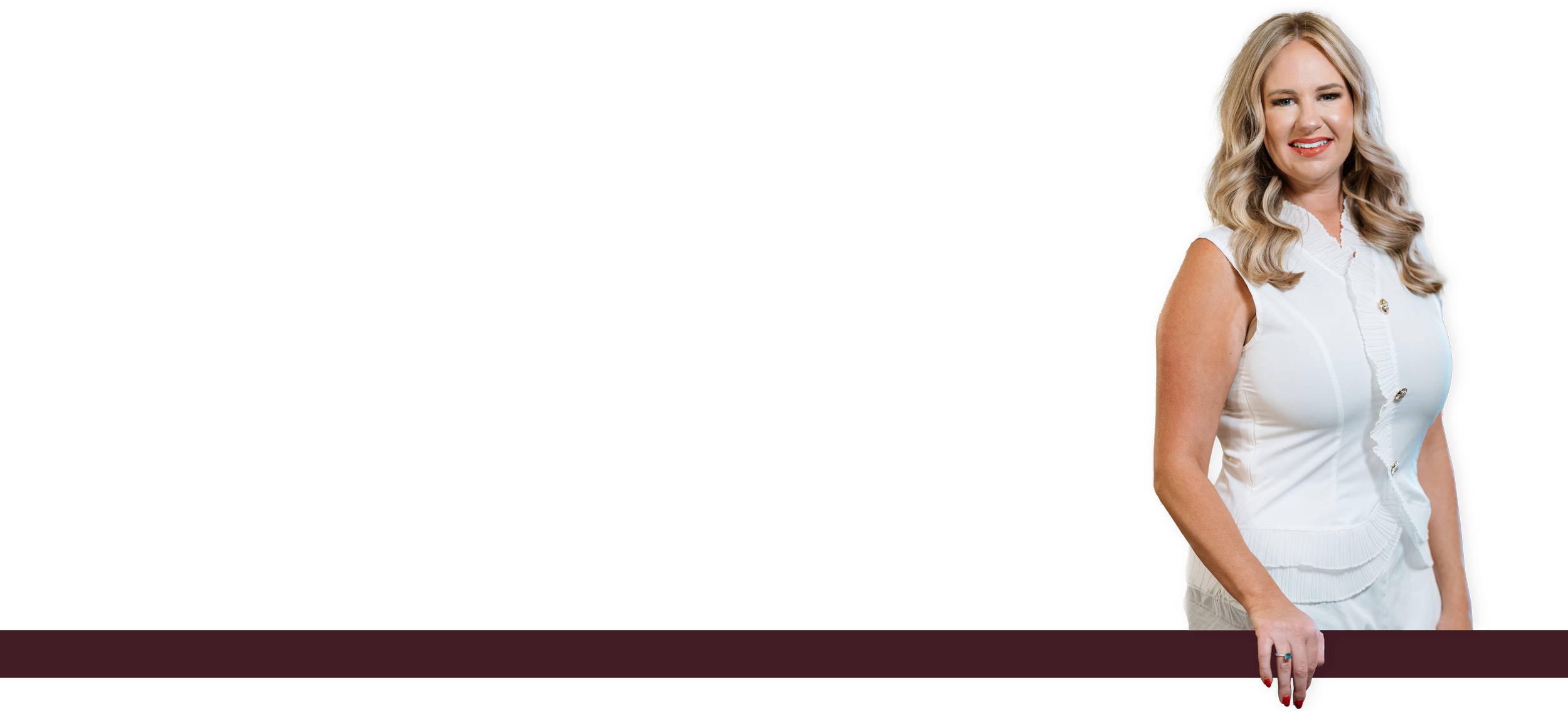 A smiling woman in a white sleeveless blouse standing against a black background.