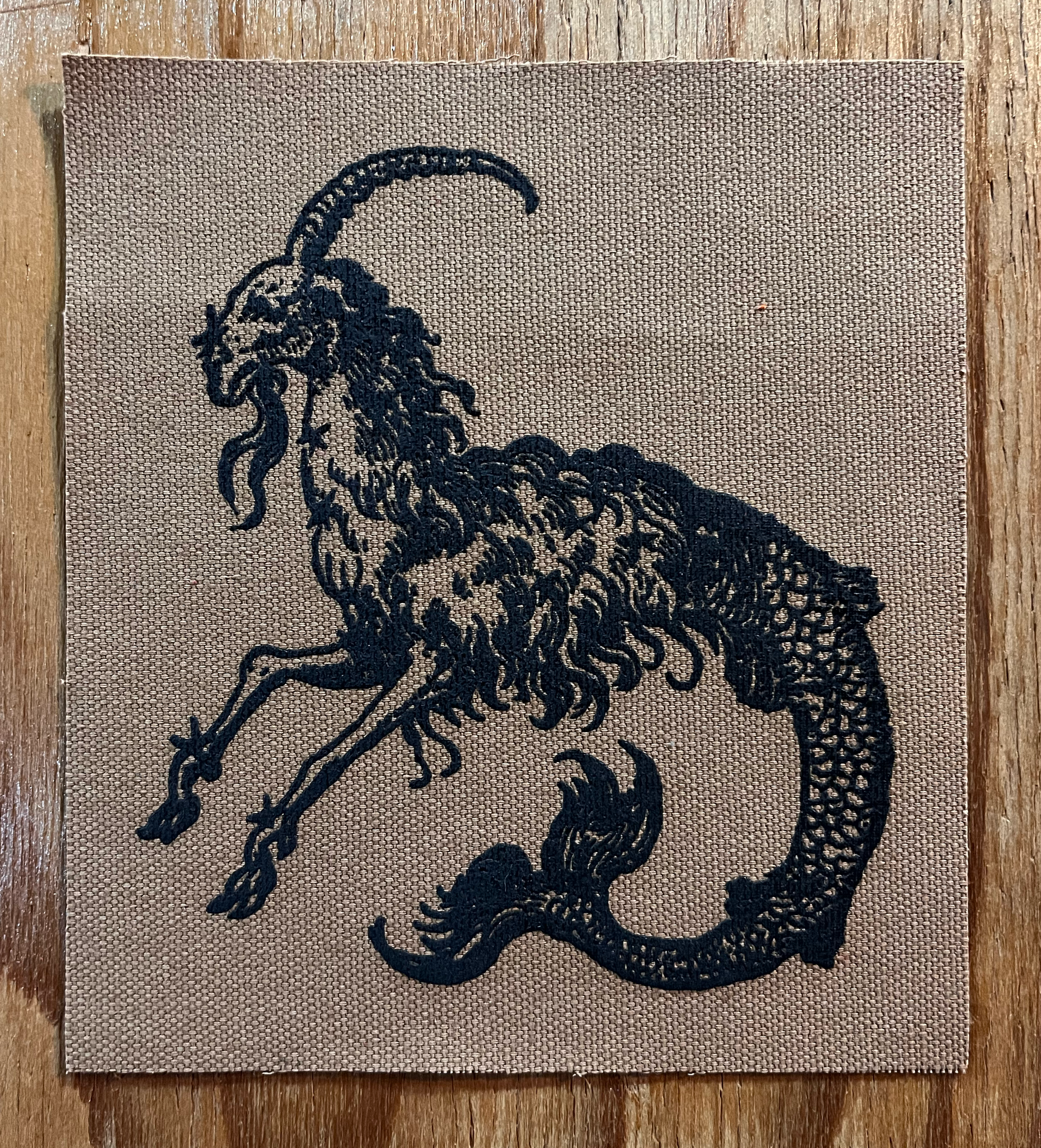 Mergoat Small Patch Black on Light Brown.png
