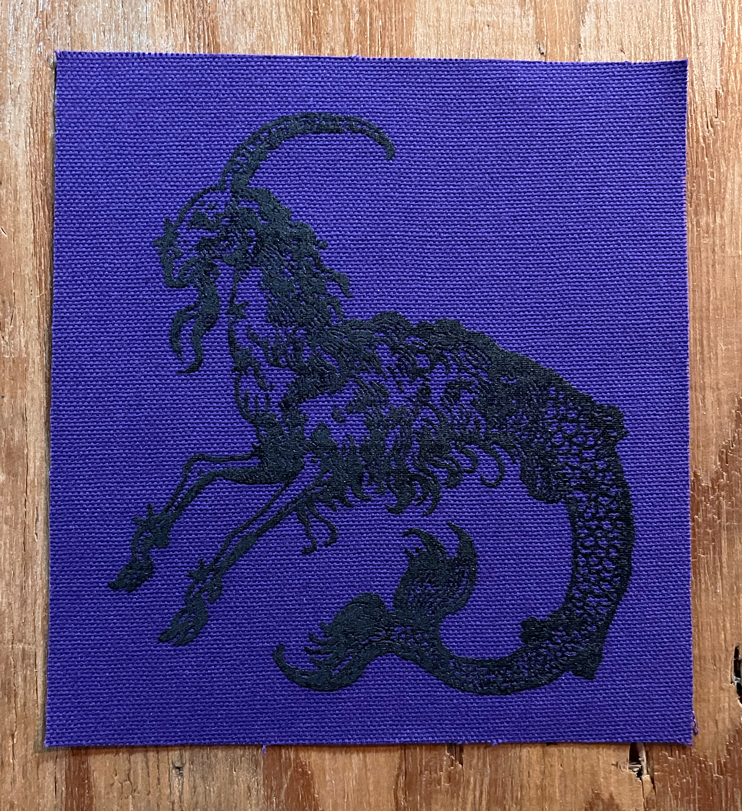 Mergoat Small Patch Black on Purple.png