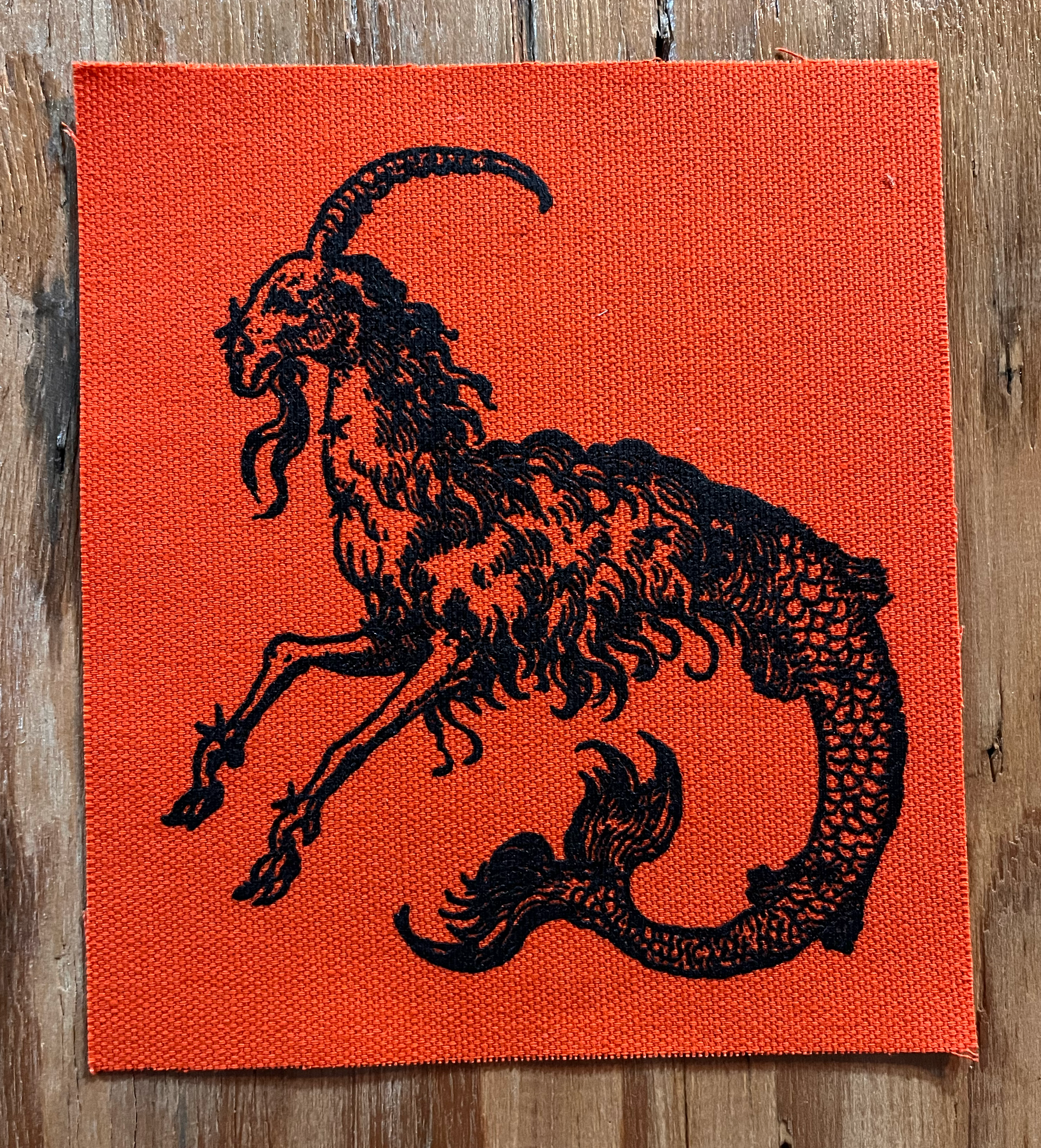 Mergoat Small Patch Black on Orange.png