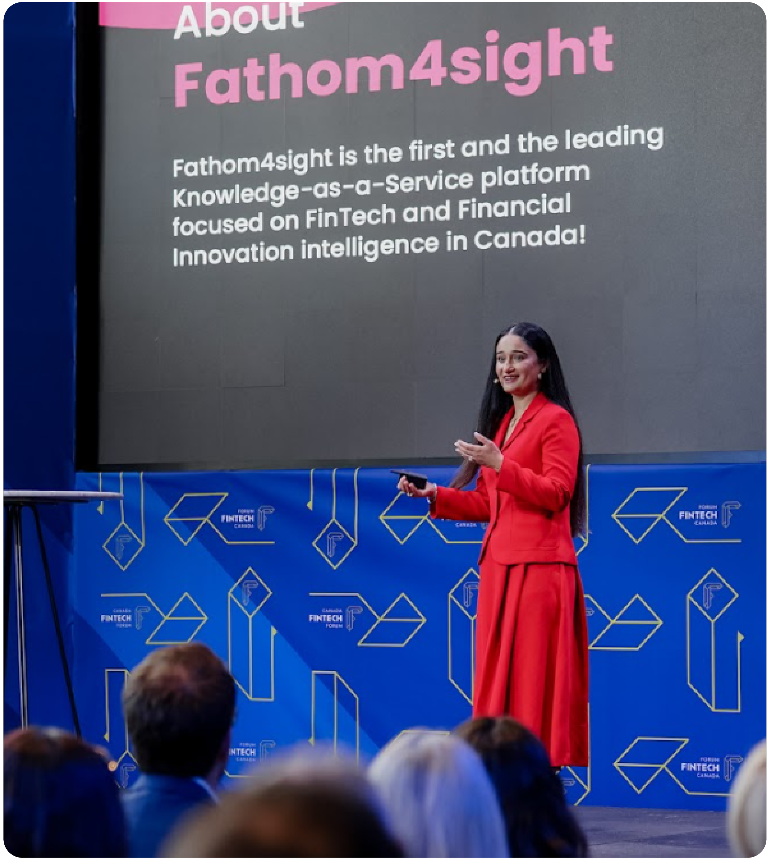 Jeet Bhatti in a red suit giving a presentation at Canada Fintech Forum 2024 with a large screen displaying the text 'About Fathom4sight' and a description about the company. There are people in the audience and a blue backdrop.