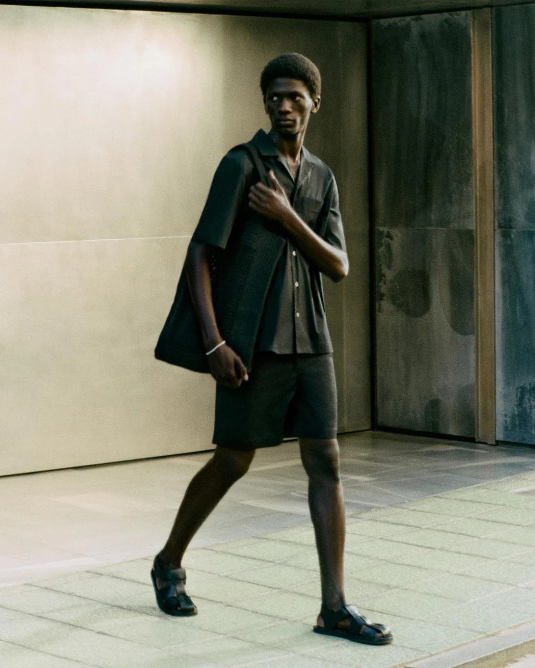 Moustapha Sy by Daniel Shea for COS Summer 2023 Ad Campaign. Hair Stylist: Ryan Mitchell. Makeup Artist: Siddhartha Simone. Art Director: Andy Knappett