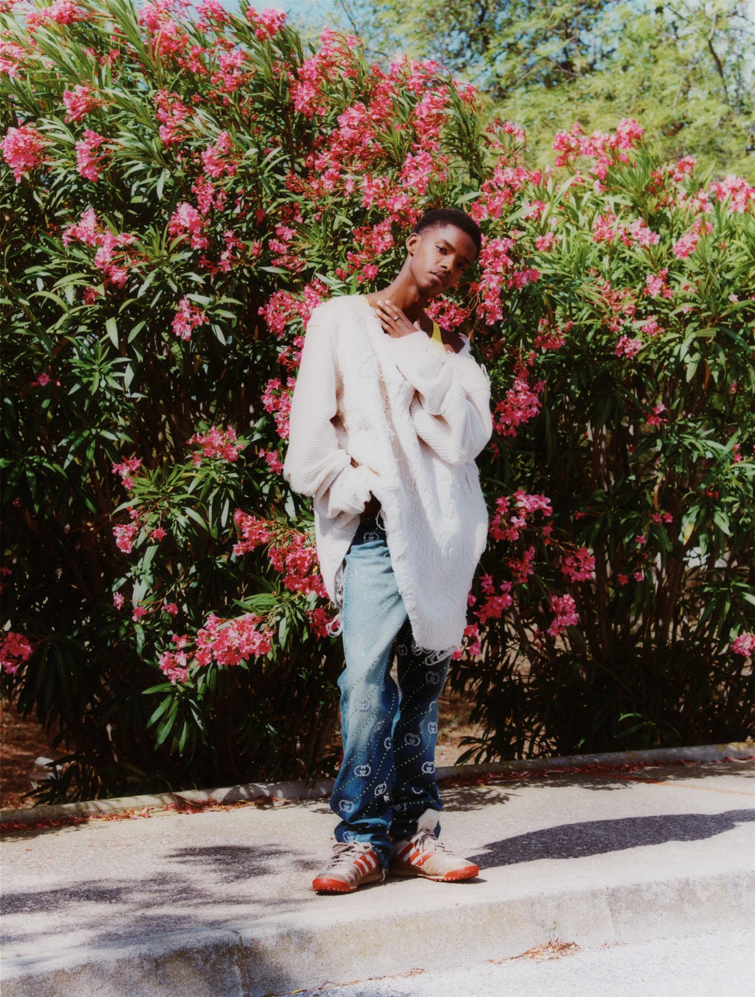 the Greatest magazine #24 – The Silence Issue styled by apolline coquet shot by Florence Mann wearing GUCCI FW23 : Blue strass embroidered washed denim pants with raw cut hems, football shoes contemporary wardrobe, knit Miriam Griffiths