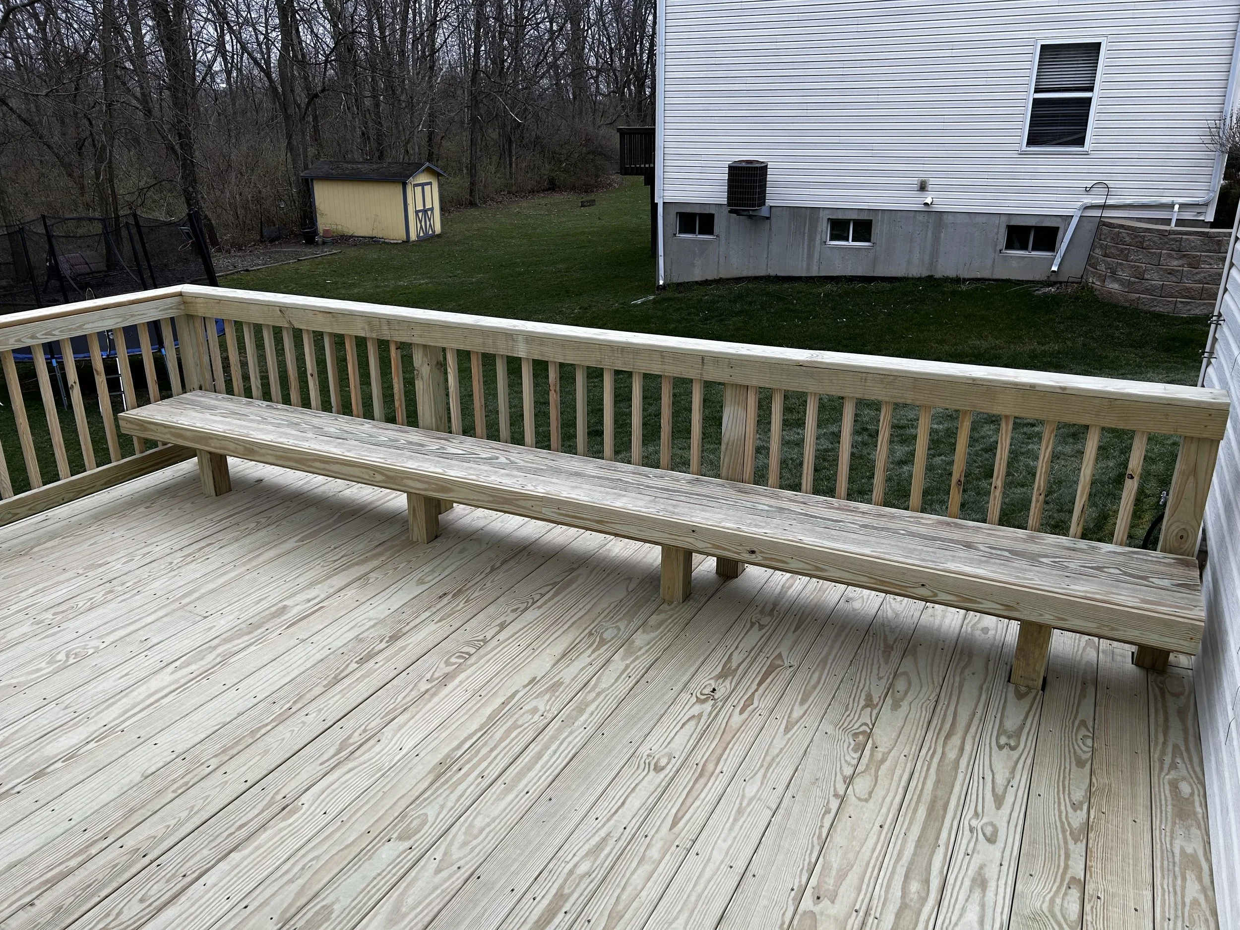 Pressure treated deck with pressure treated railing, and custom-built pressure treated bench
