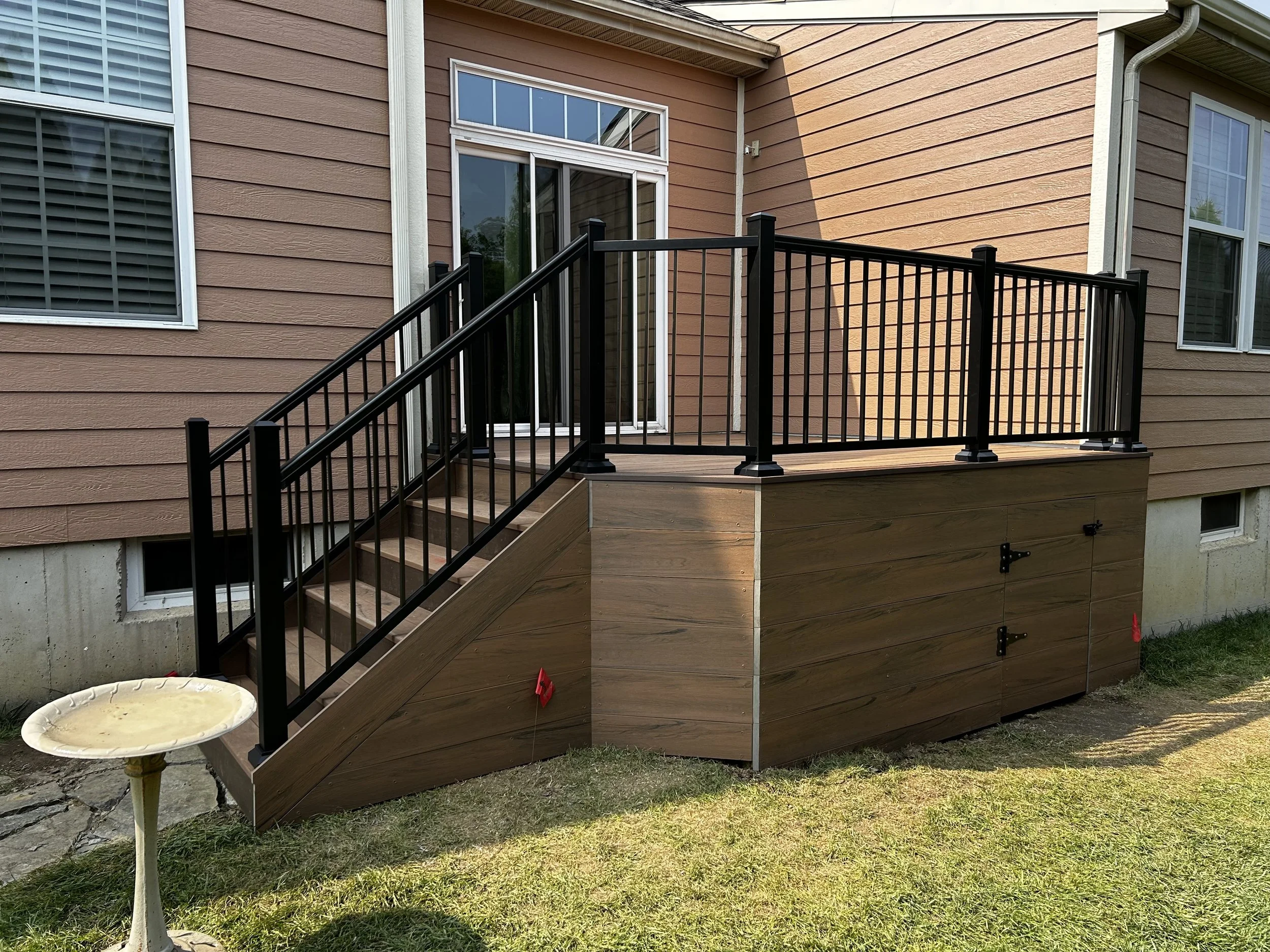 serving the Miami Valley, Dayton, and surrounding areas.  Raised composite deck with black aluminum railings and built-in storage underneath