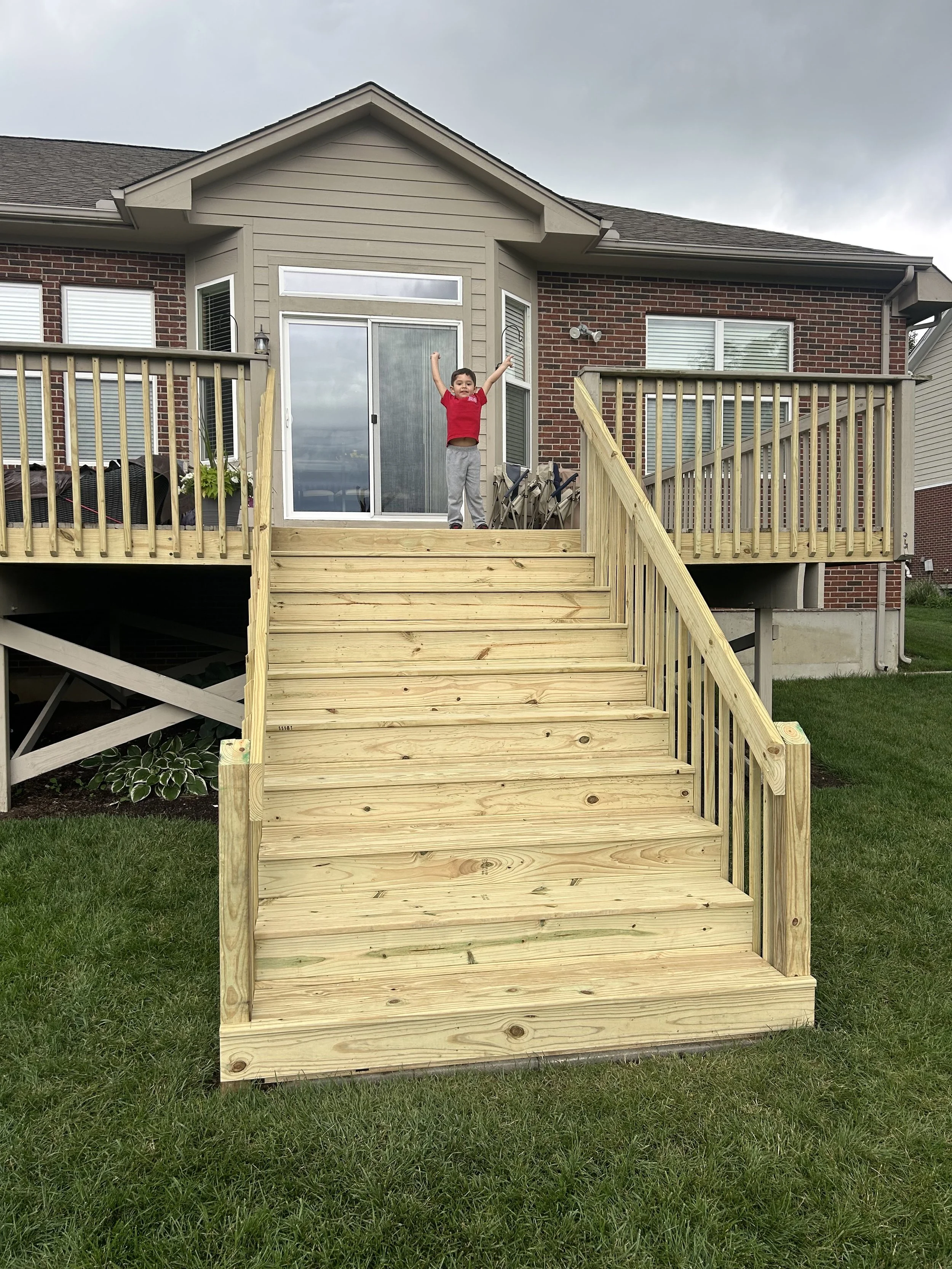serving the Miami Valley, Dayton, and surrounding areas.  Pressure-treated wood deck with wide staircase and railings.