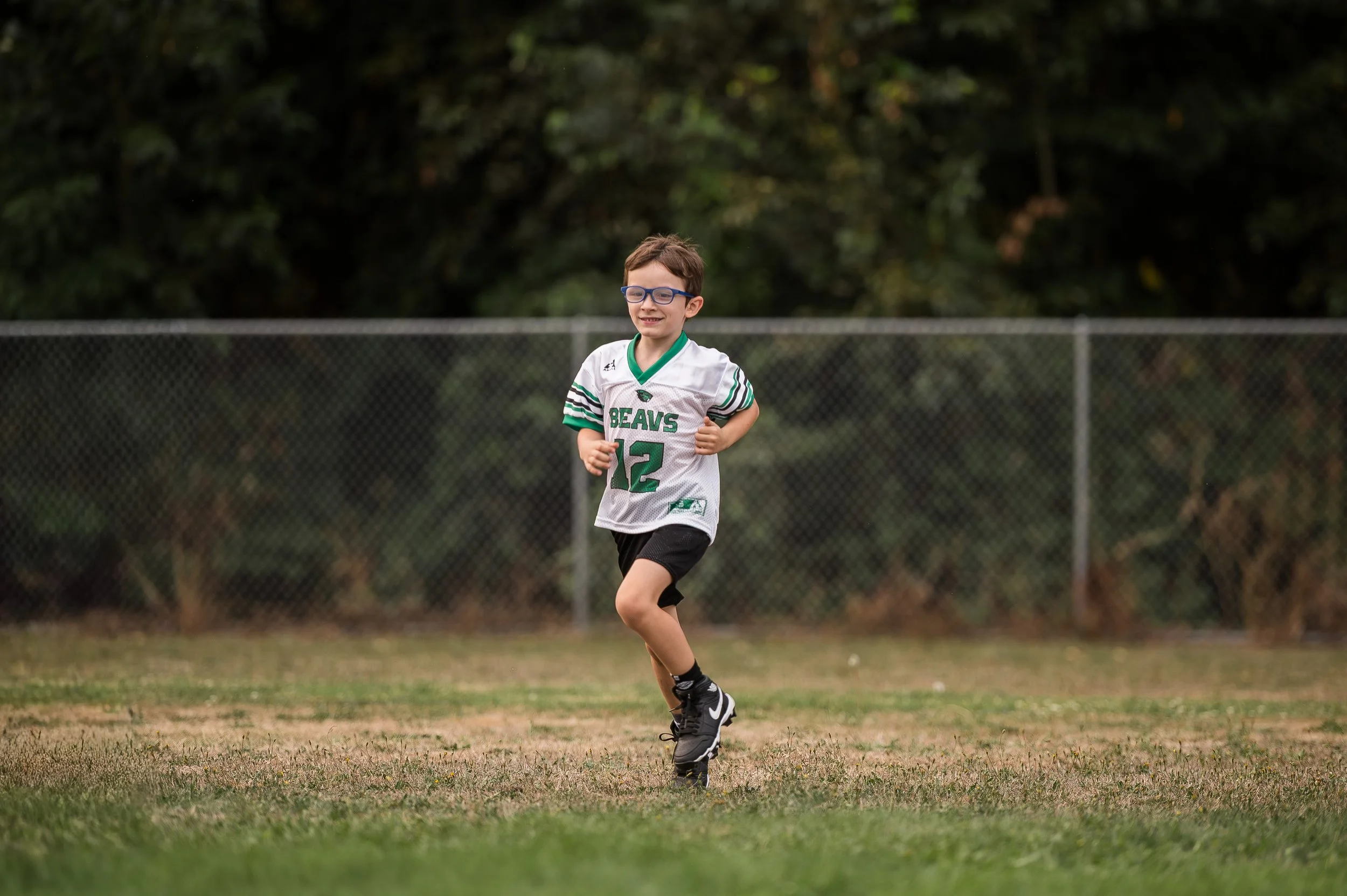 Youth athlete running outdoors during summer conditioning to build endurance and offseason wrestling performance