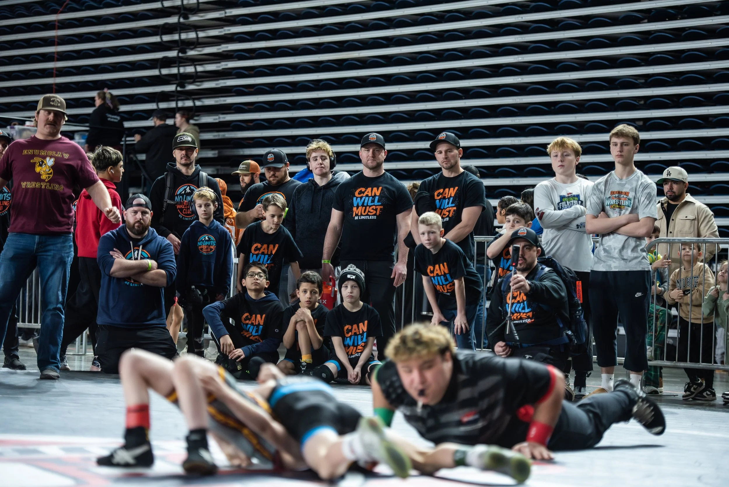 Wrestling coaches together during a youth wrestling event