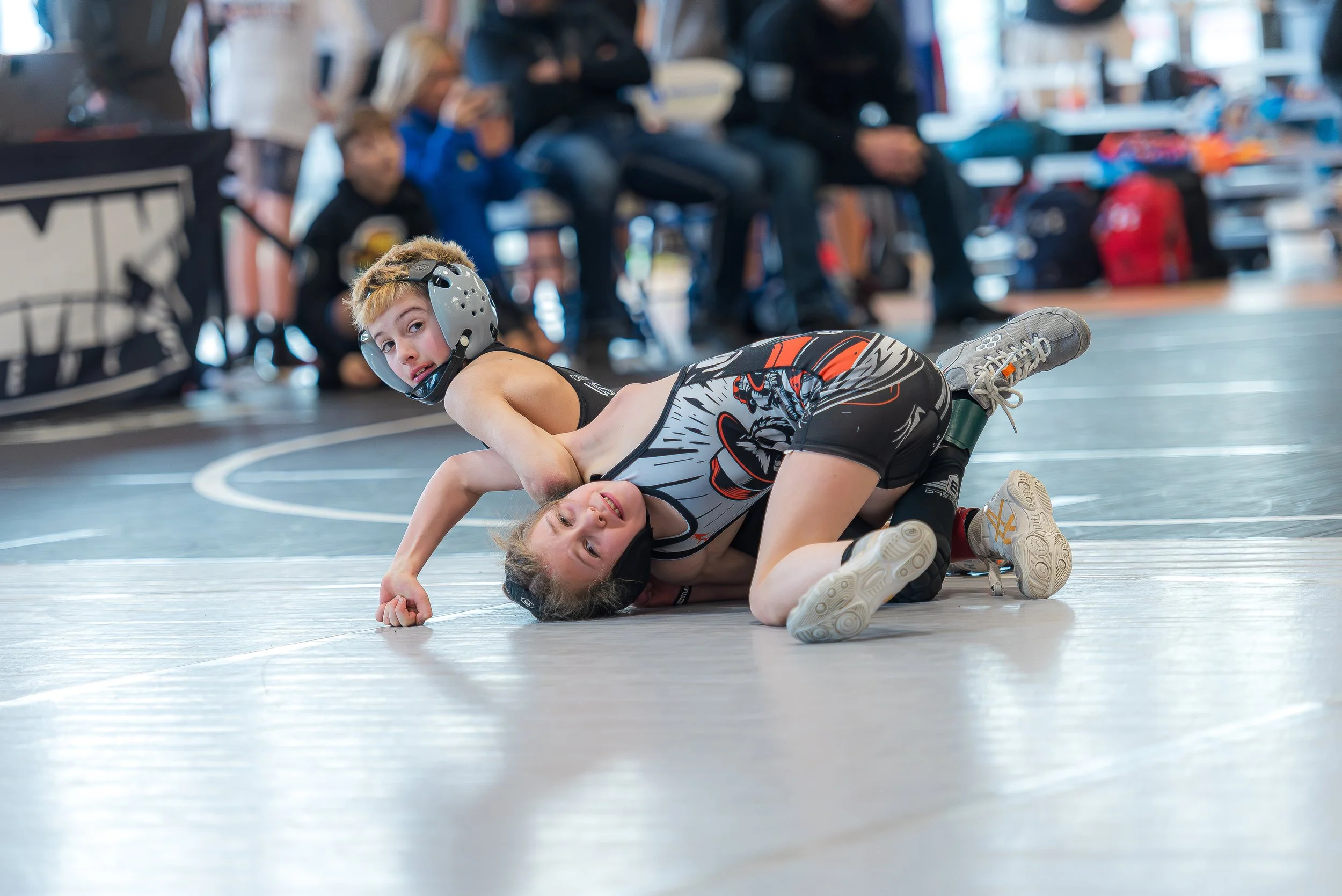 Group of youth wrestlers competing at a tournament, reflecting long-term athletic development and healthy participation in youth sports.