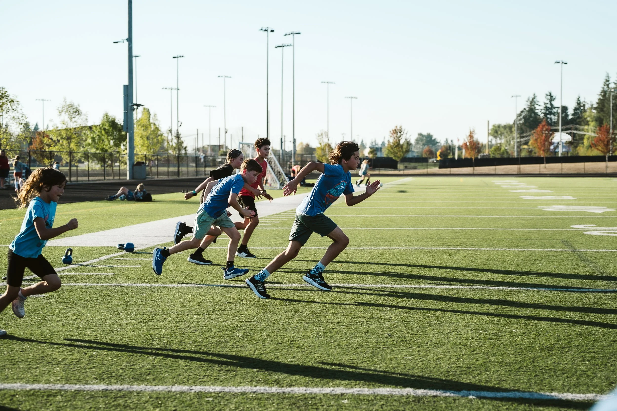 Youth athletes performing Zone 2 summer conditioning and sprint training during offseason sports development program