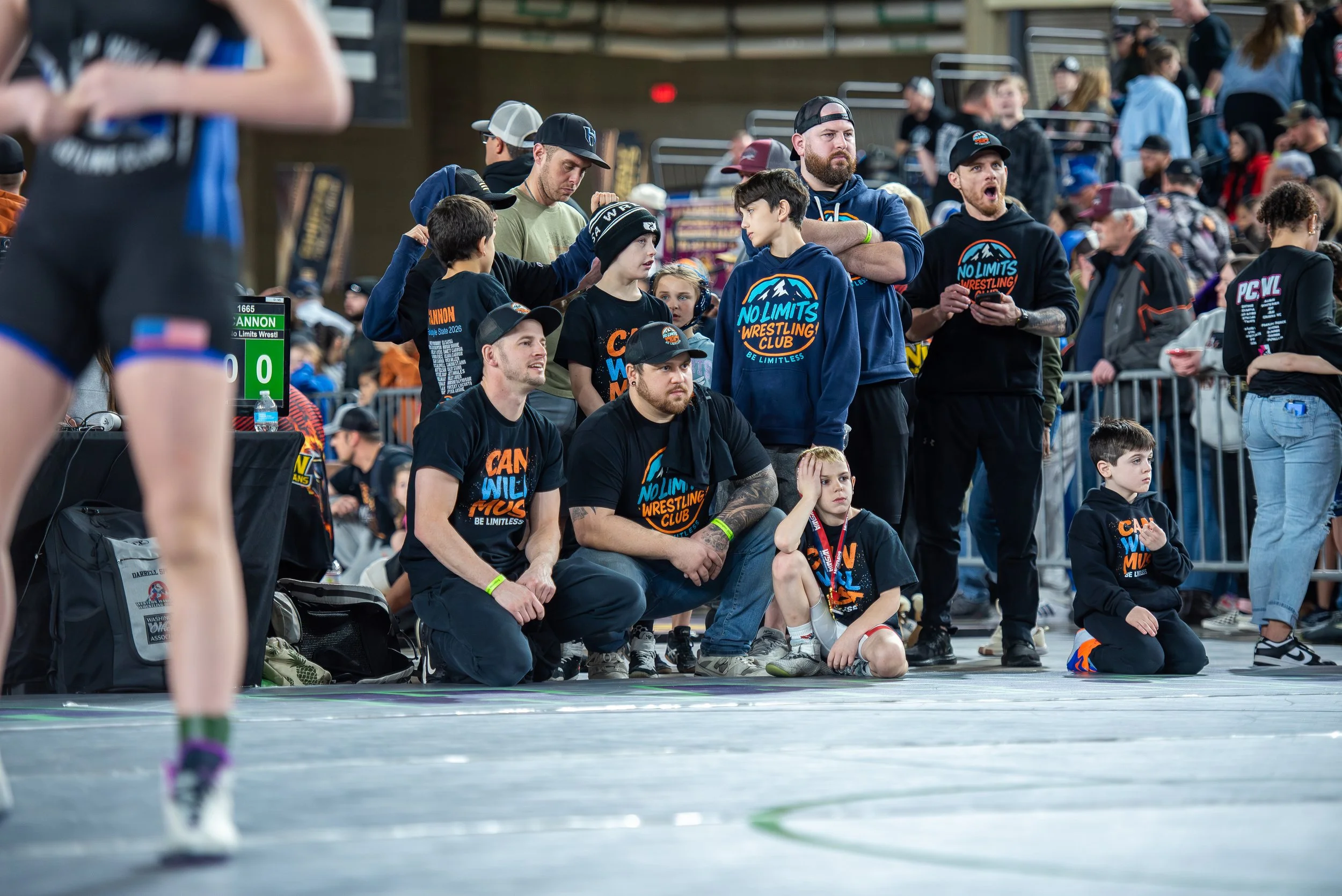 Youth wrestling coaches working with athletes at No Limits Wrestling Club in Southwest Washington